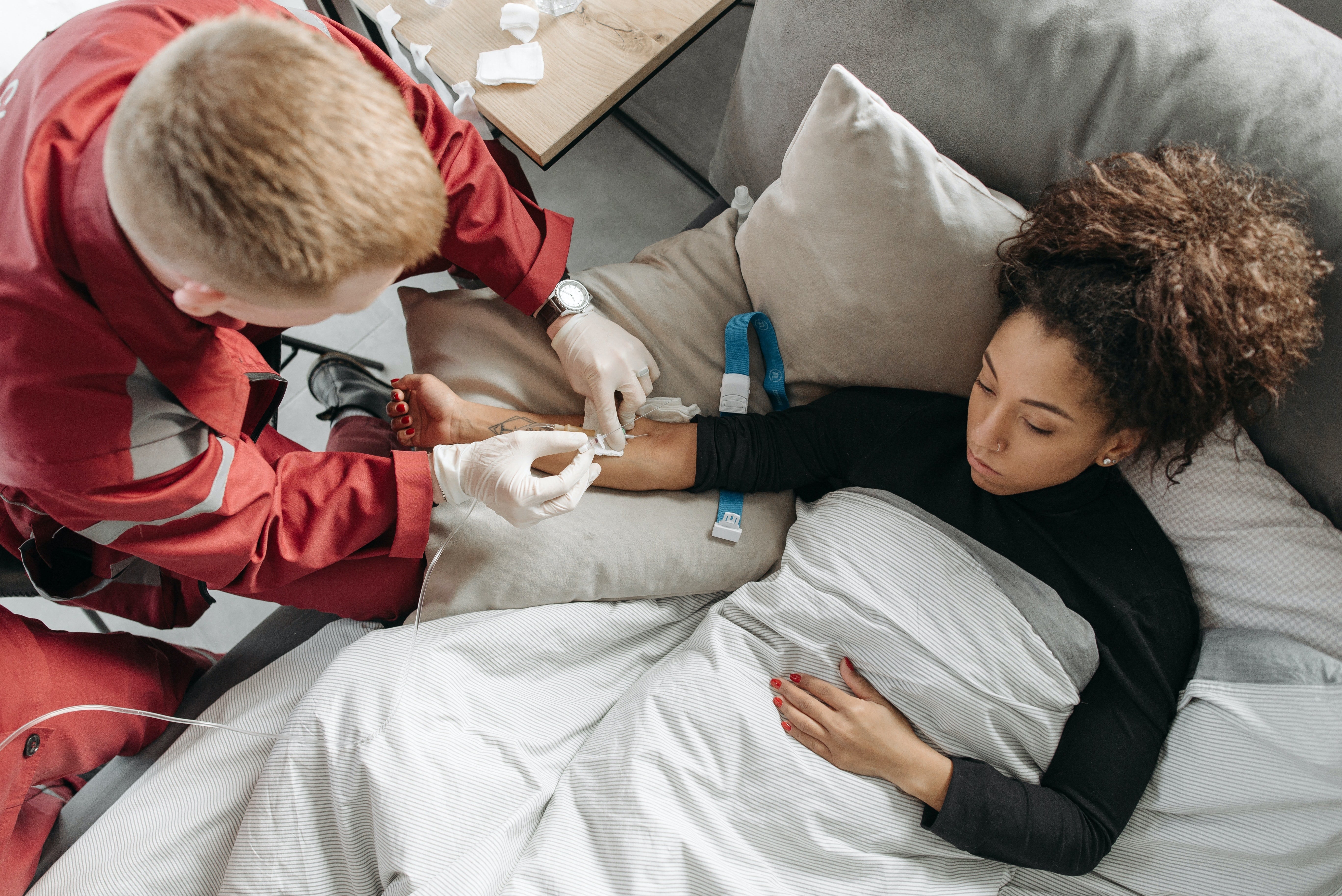 Paramedic assisting a female patient