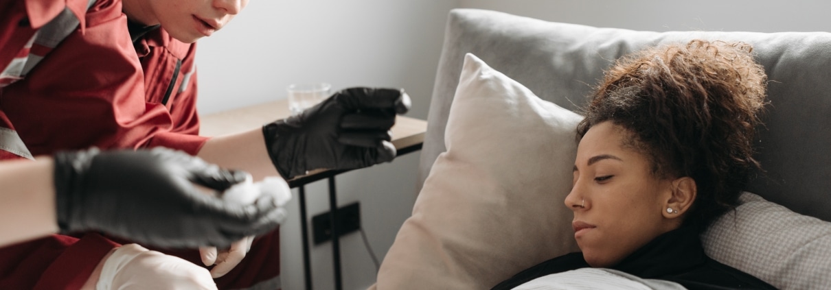 Two paramedics assisting a patient