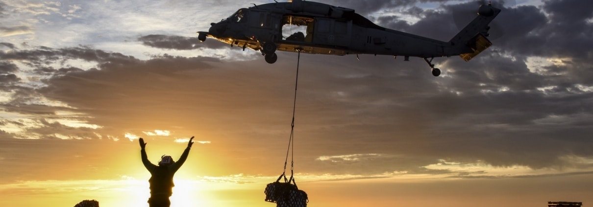 Military helicopter delivering supplies