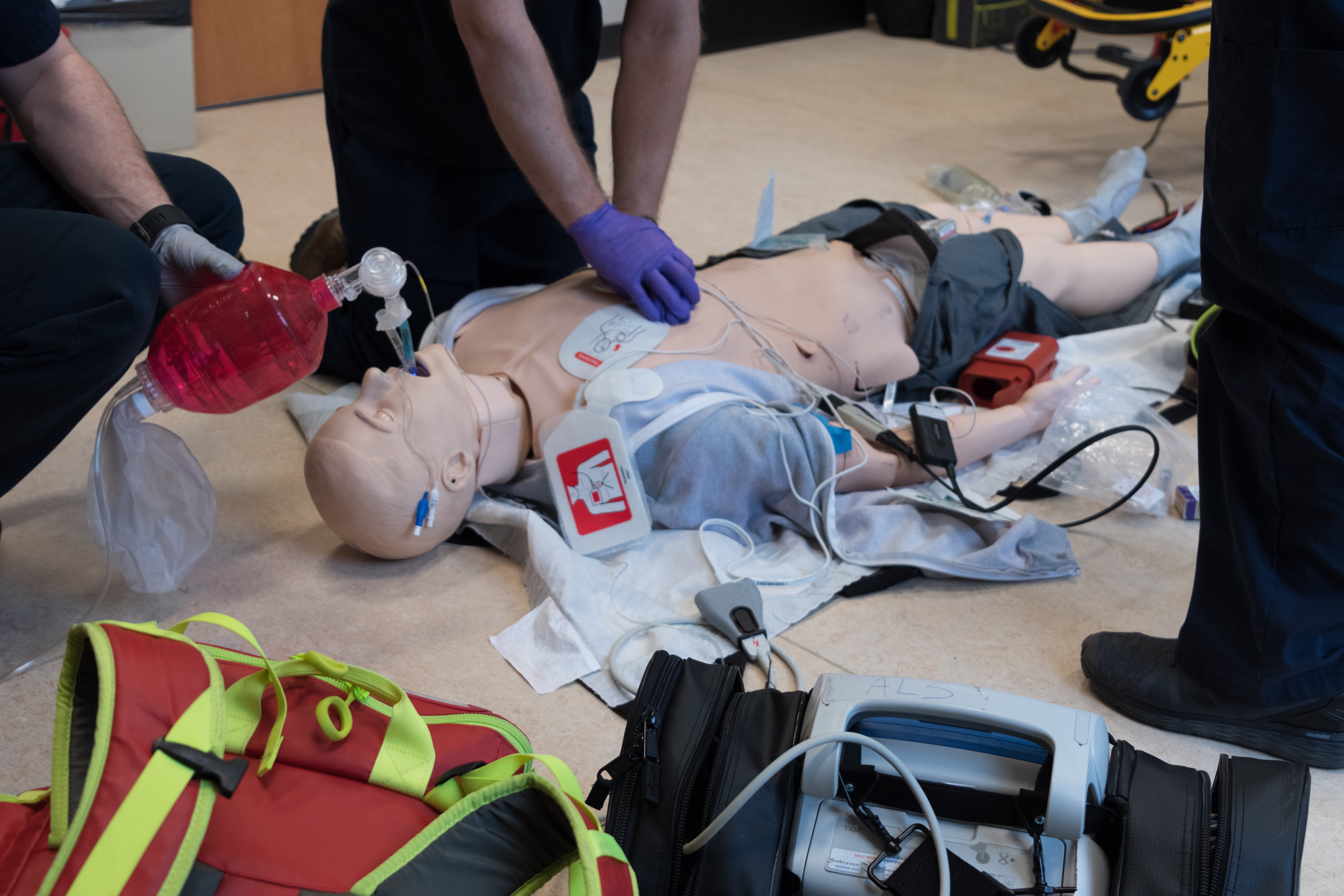 Aspiring paramedics training with a mannequin