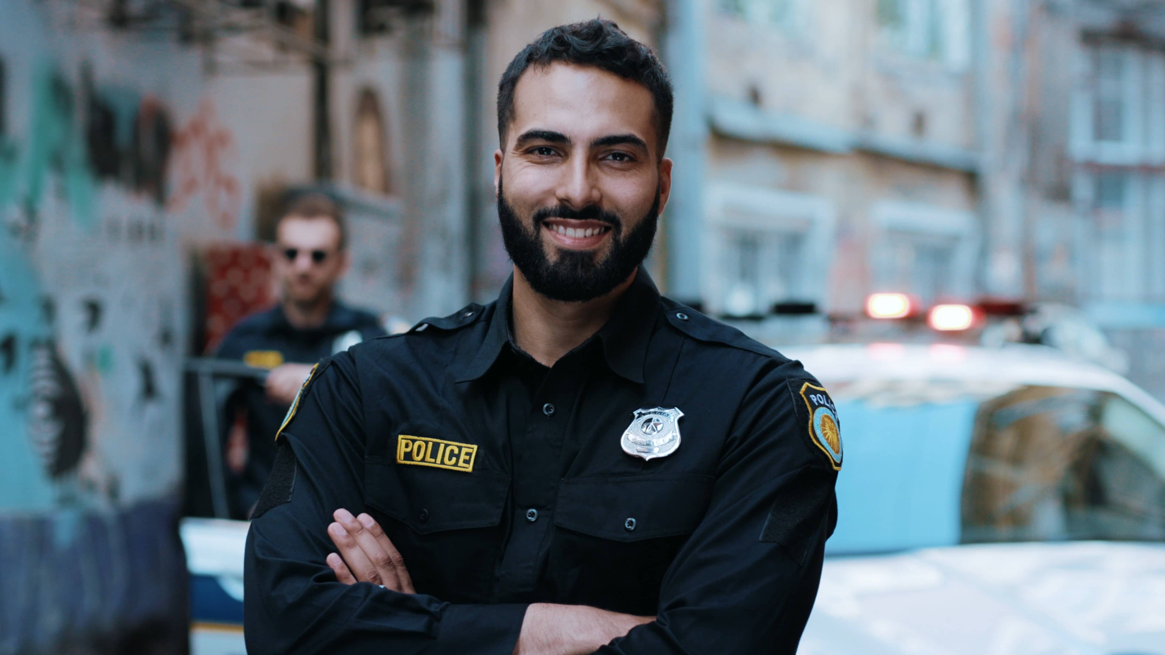 Smiling young cop in a city neighborhood
