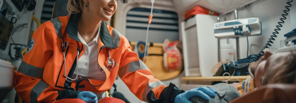 Female EMS professional comforting a man