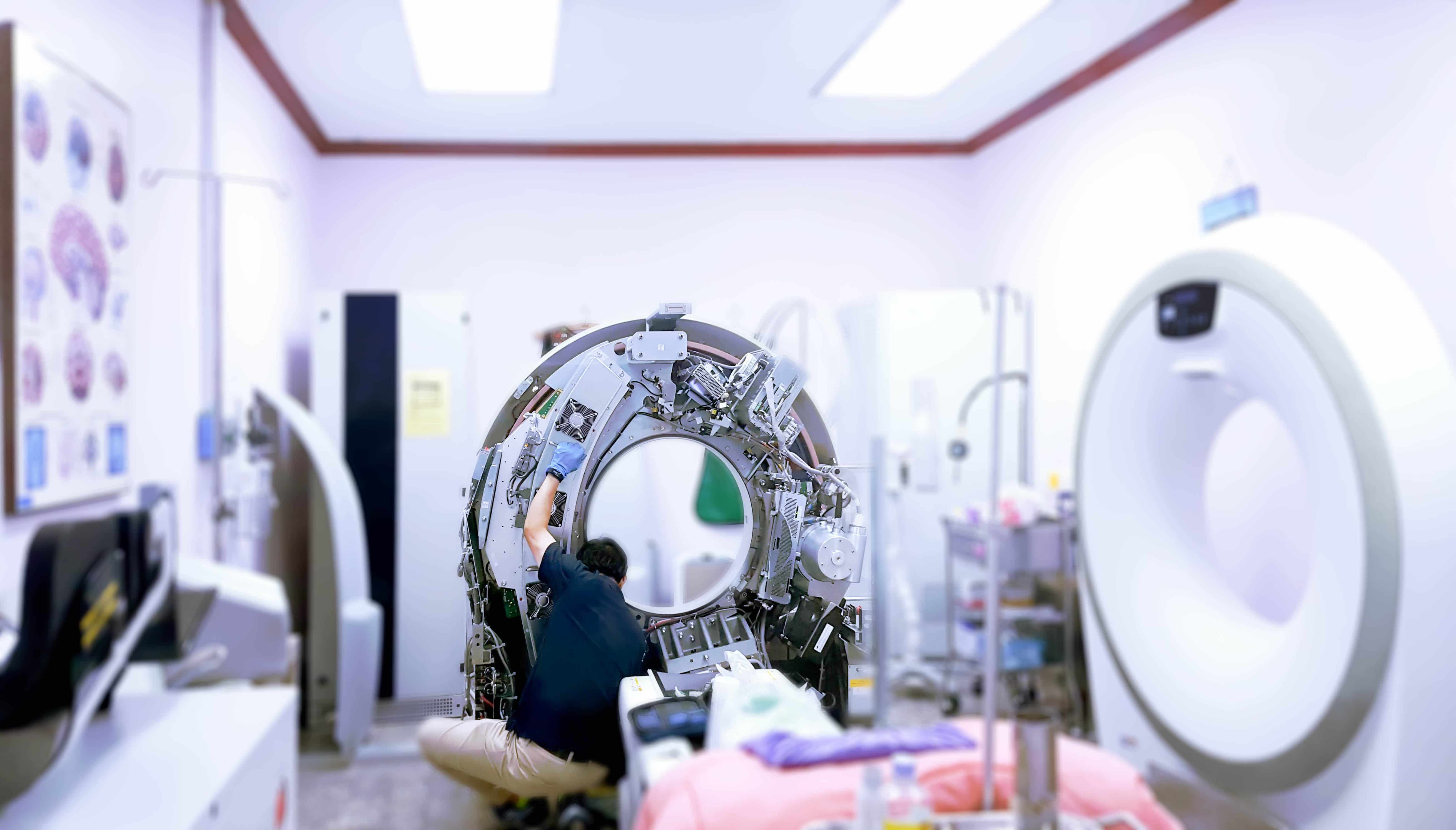 Medical equipment repairer checking a machine