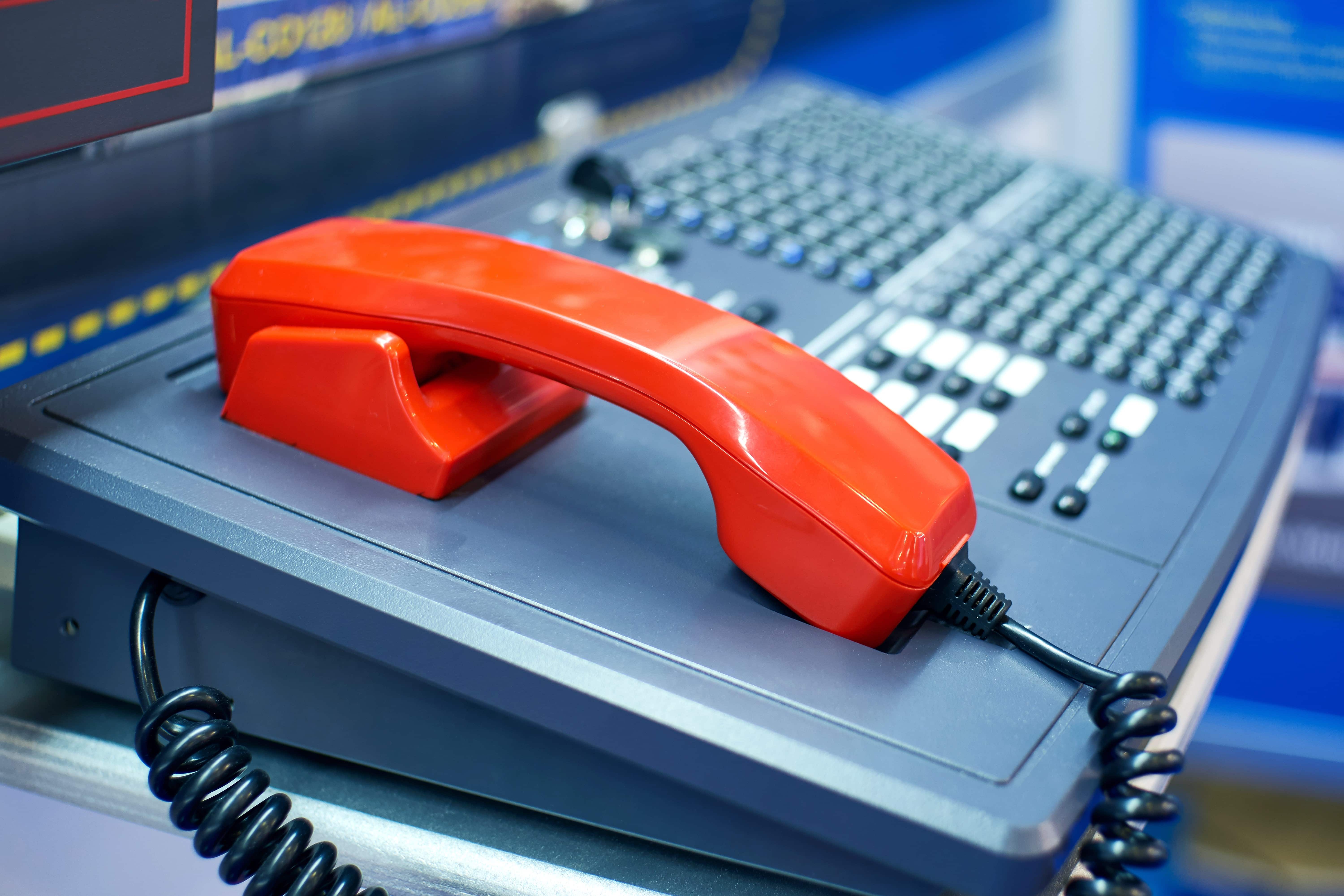 Close up of desk with red telephone
