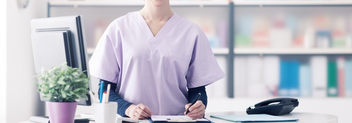 Female medical professional working at a desk
