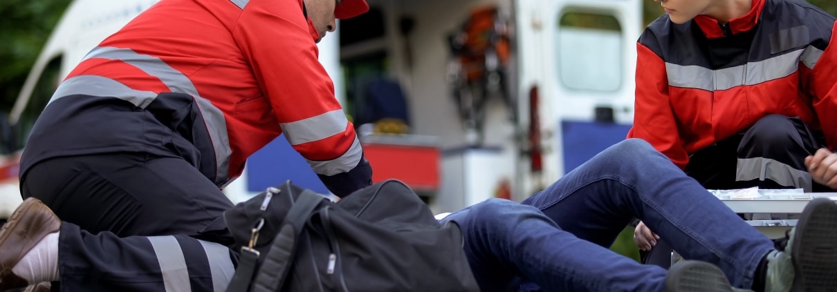 EMS team helping a patient on the road