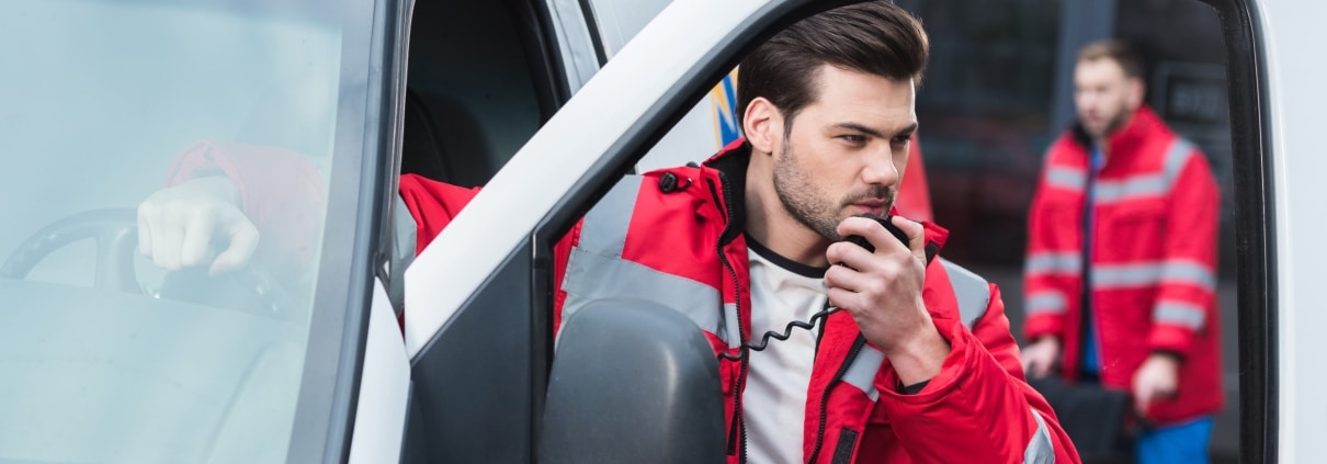Male EMS professional using a portable radio