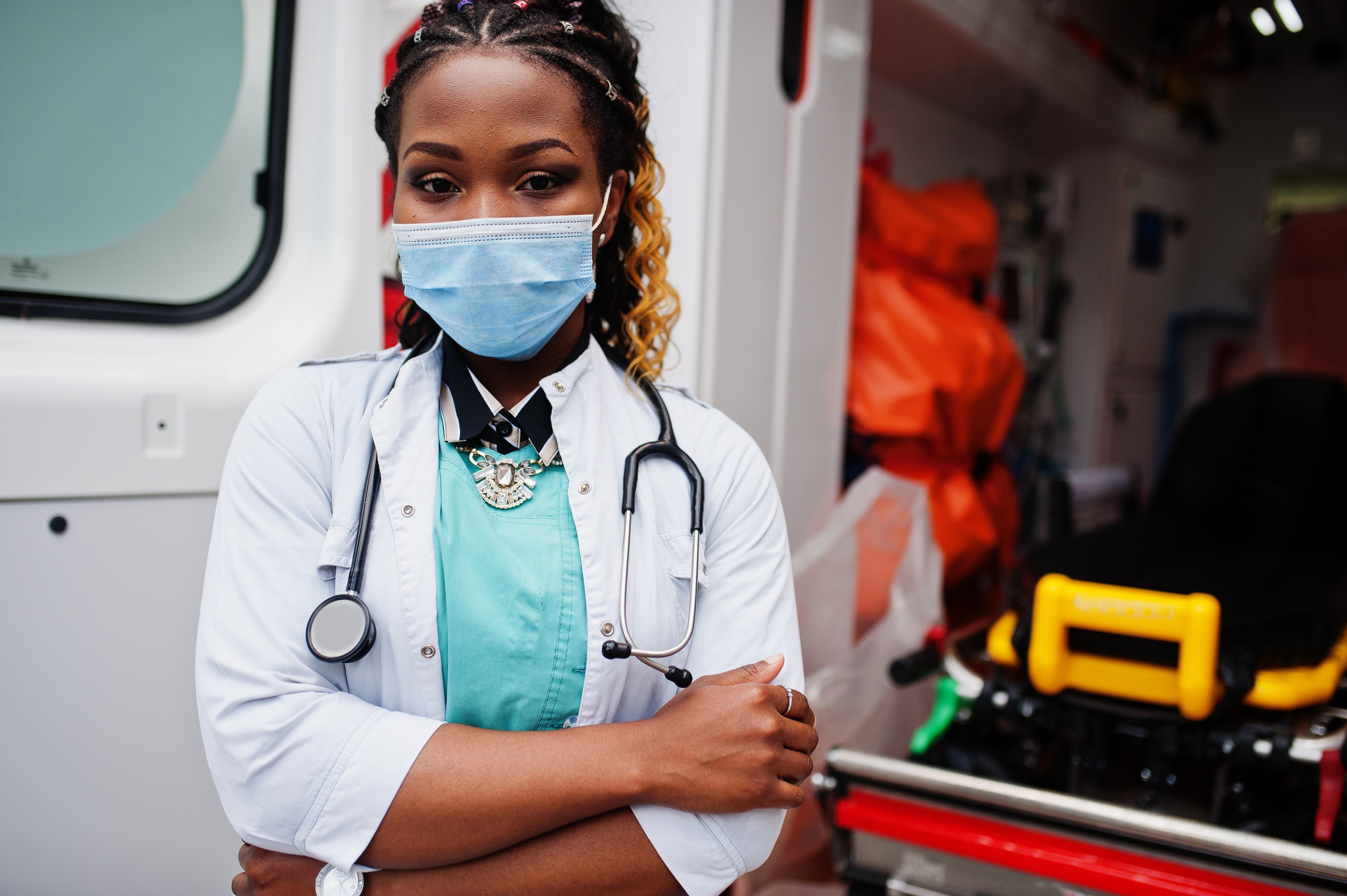 African-American medic next to an ambulance