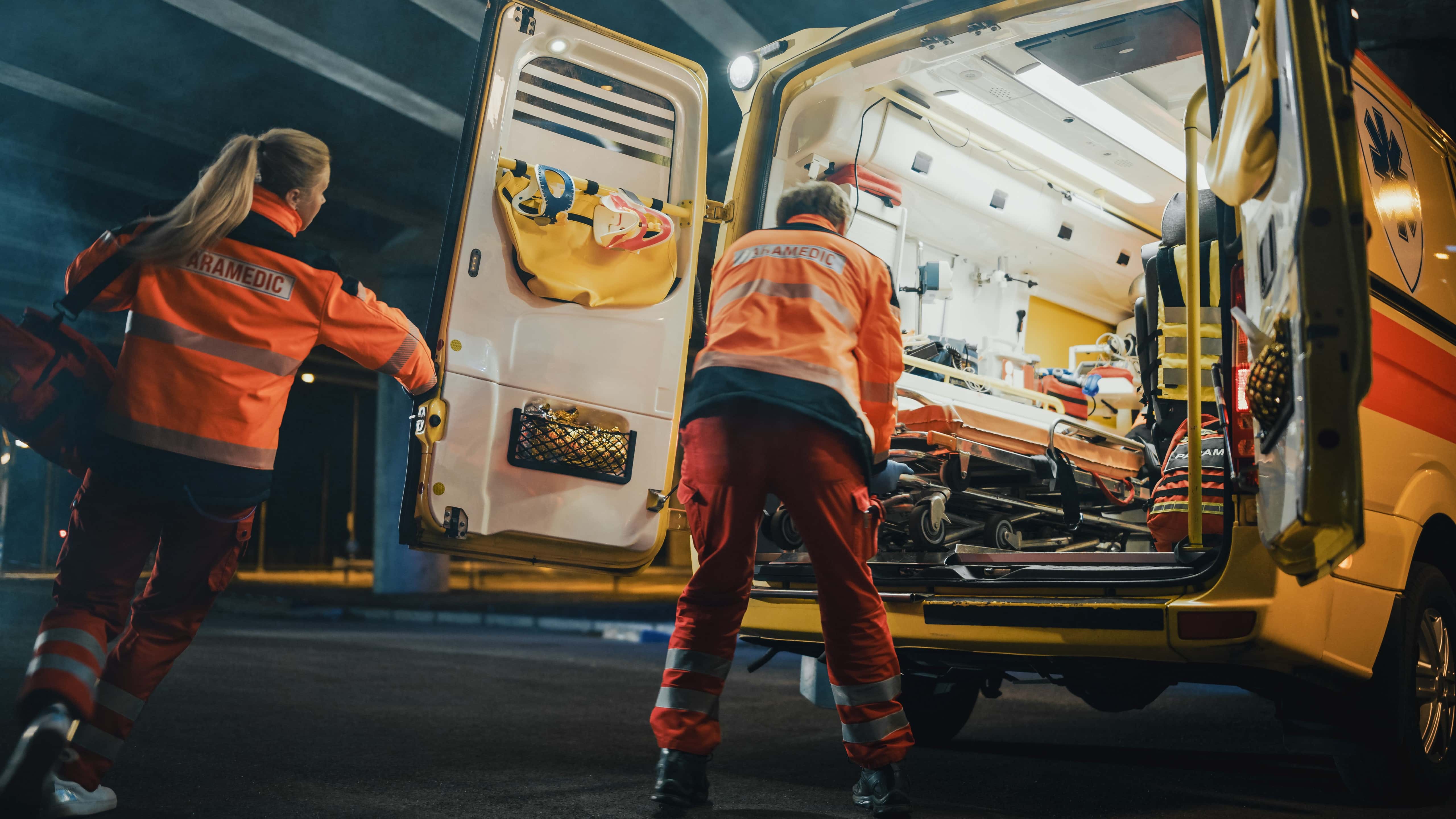 Team of EMS professionals moving a patient