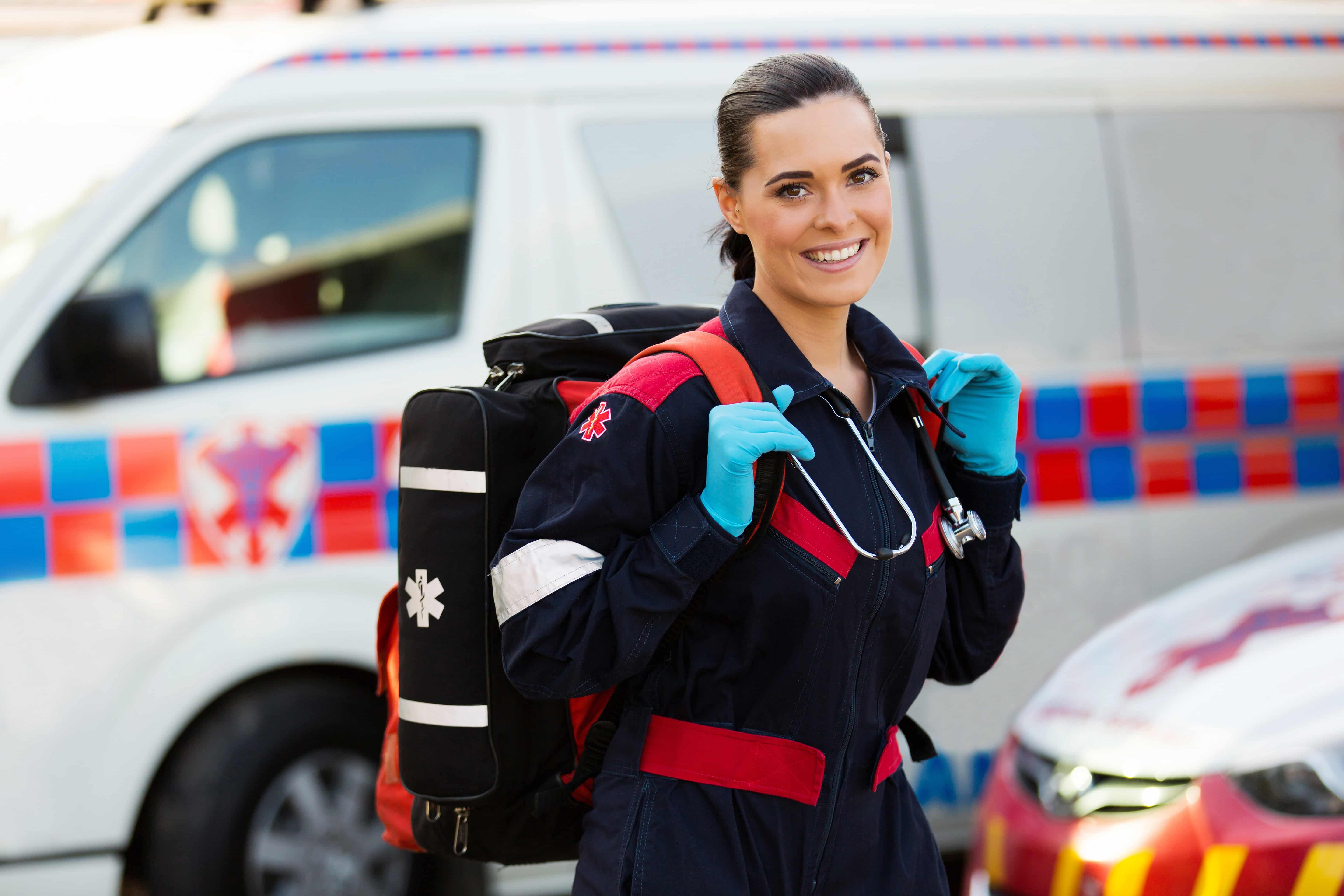 Young EMS professional carrying a backpack