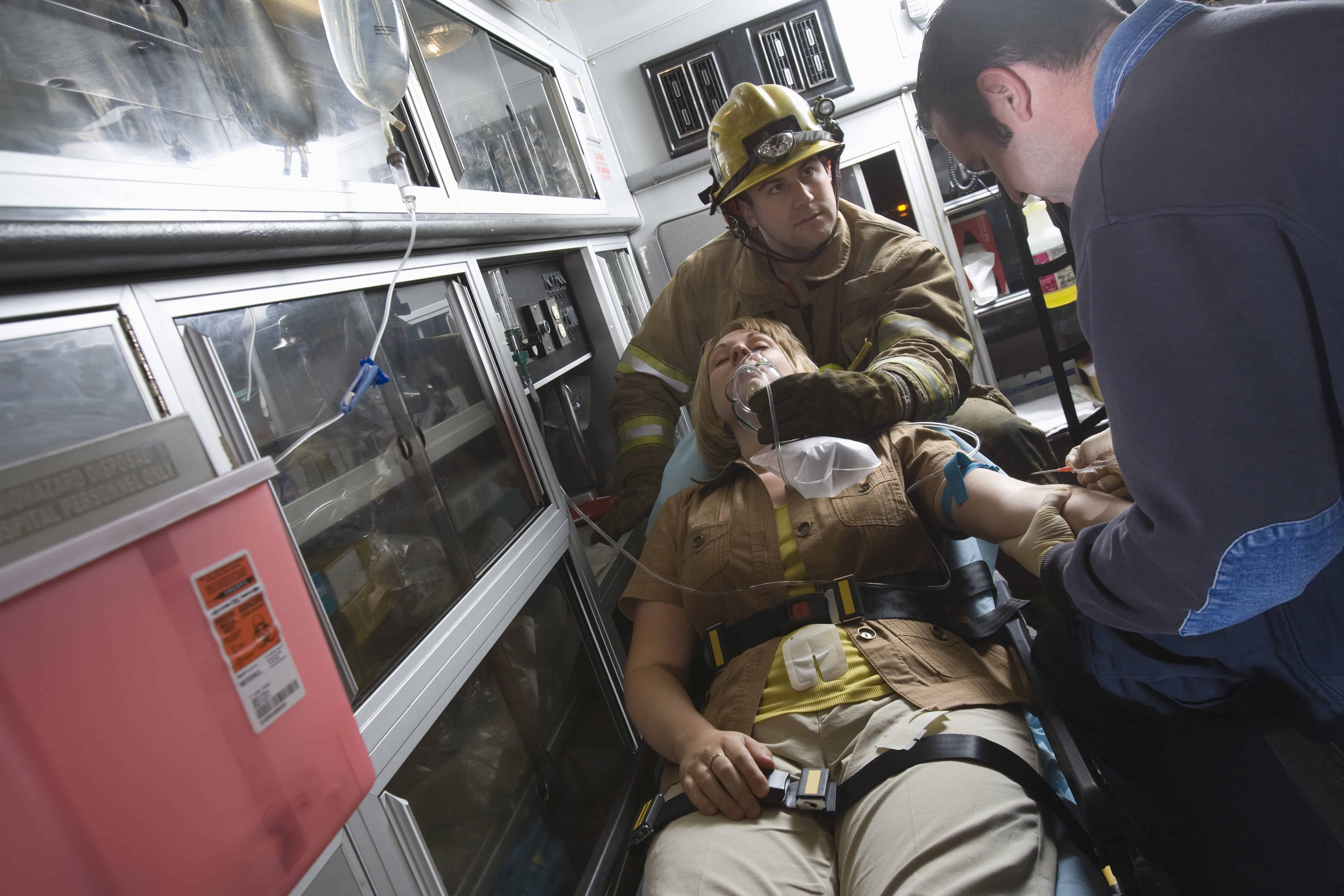 EMS professionals with a woman on a stretcher