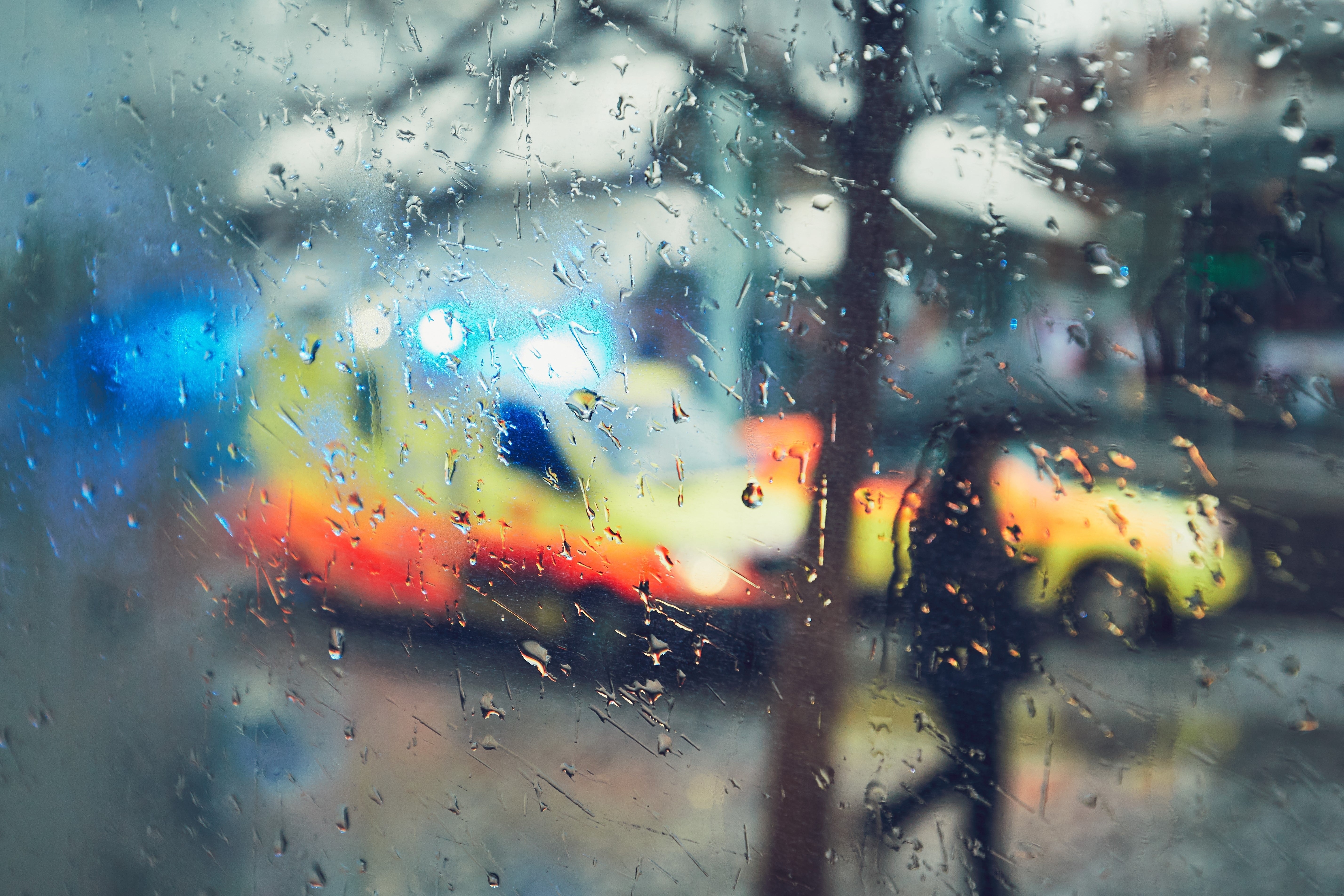 View of an ambulance through a rainy window
