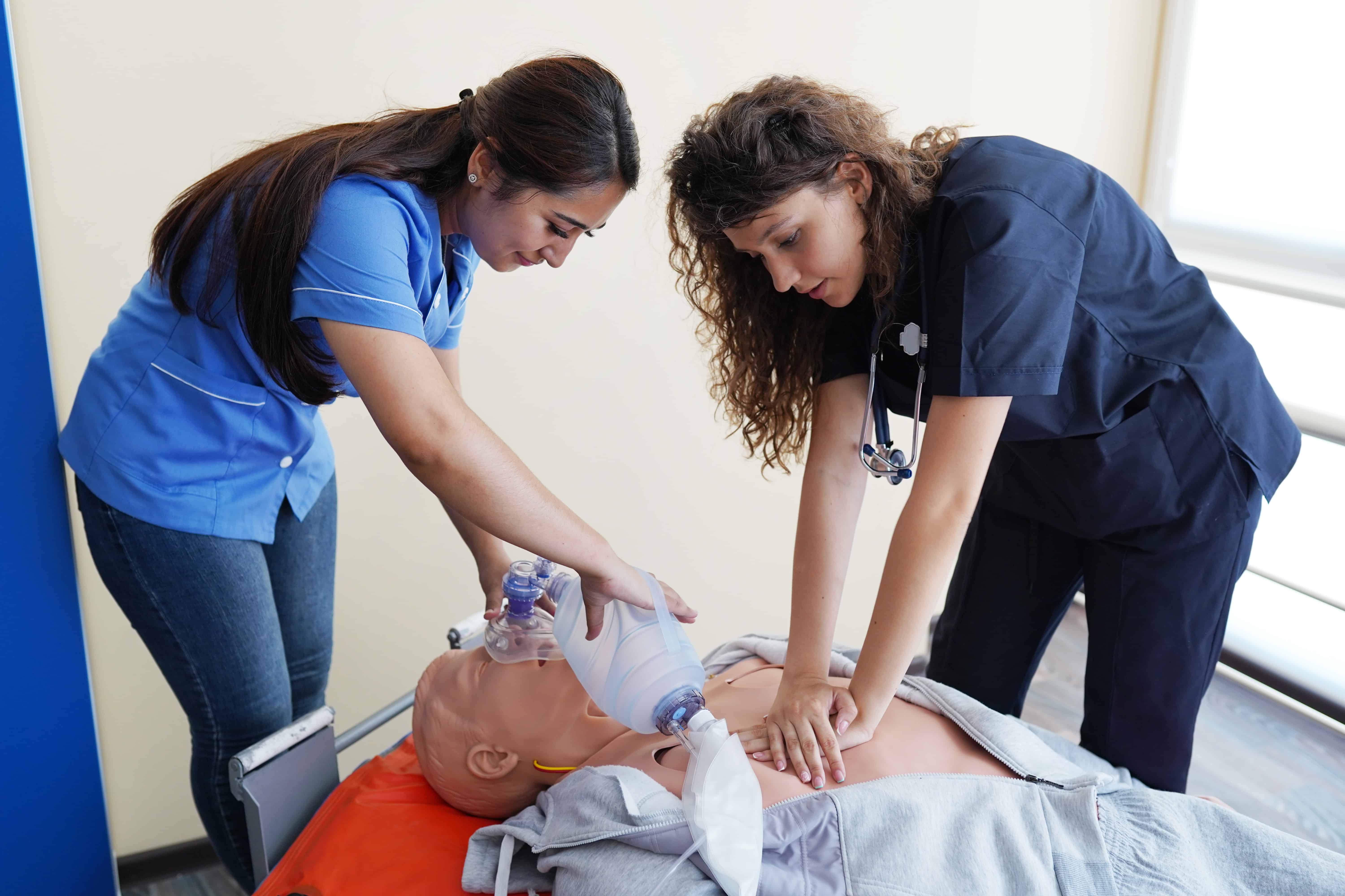 Students practicing on a medical mannequin