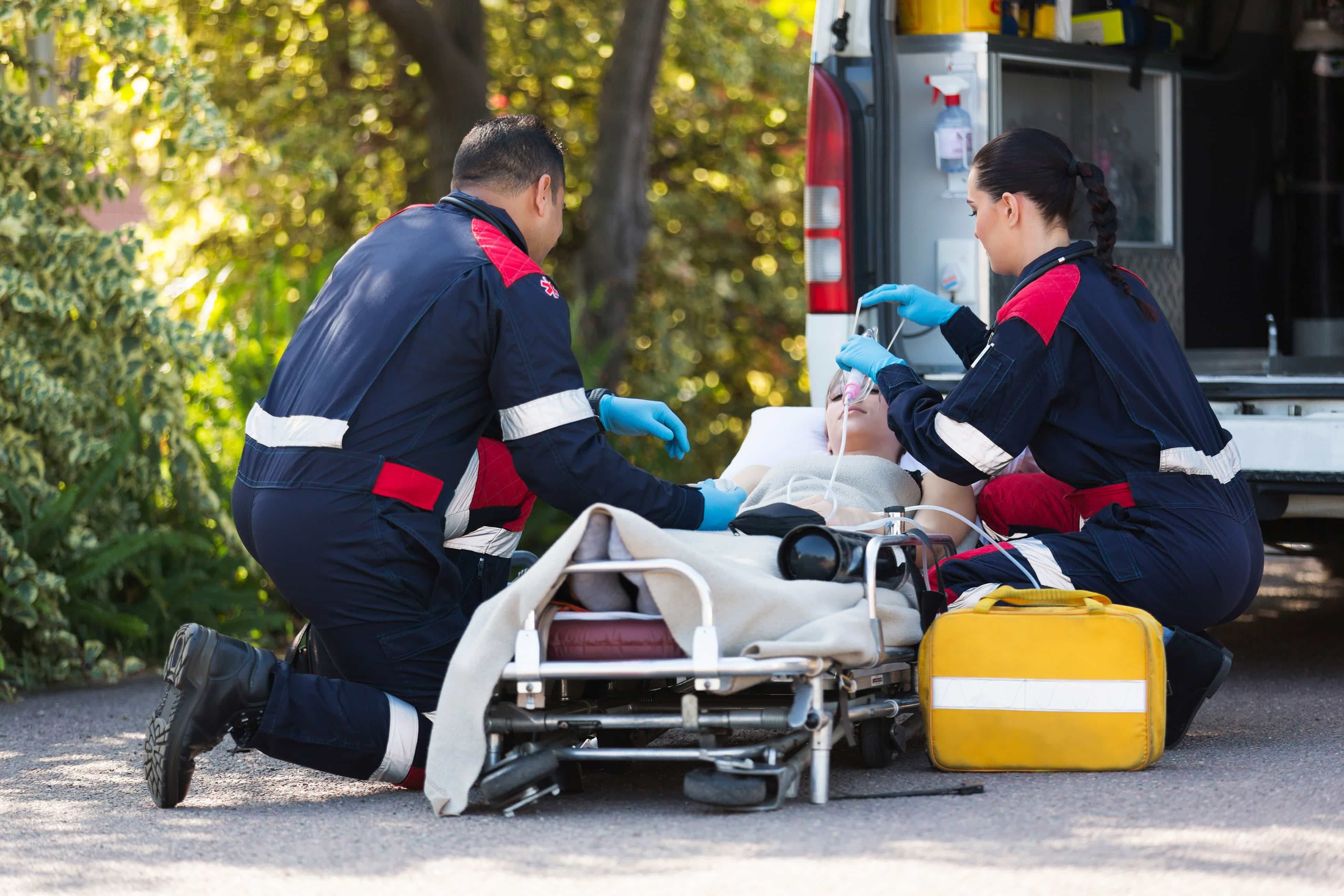 EMS workers with woman on a stretcher