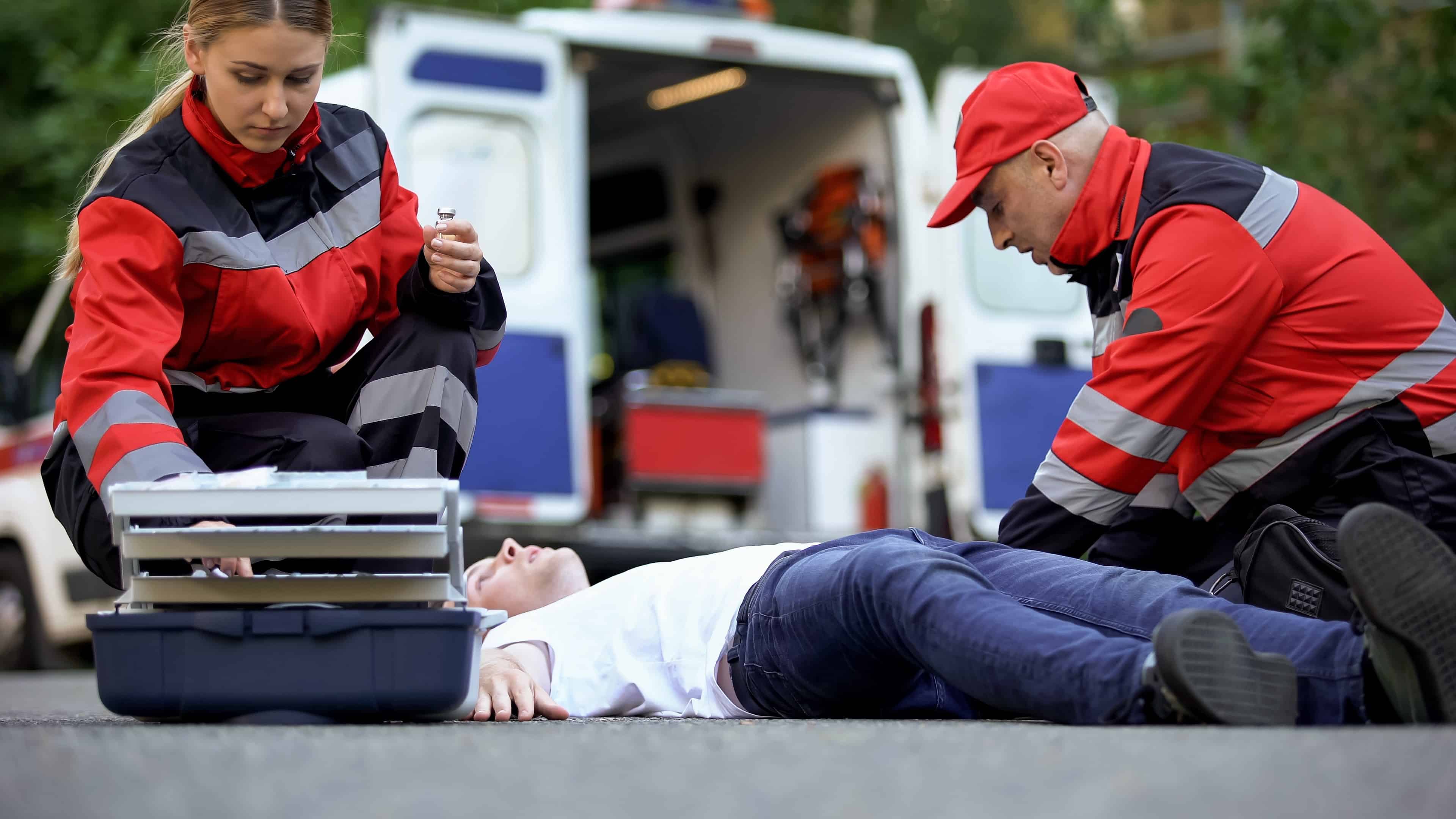 Medics helping a man on the road