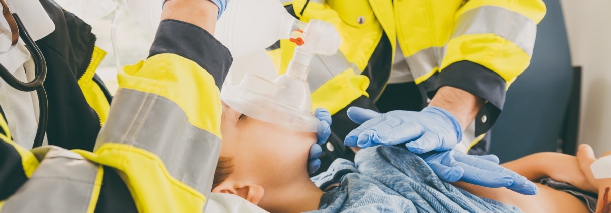 Close up of EMS professionals helping a child
