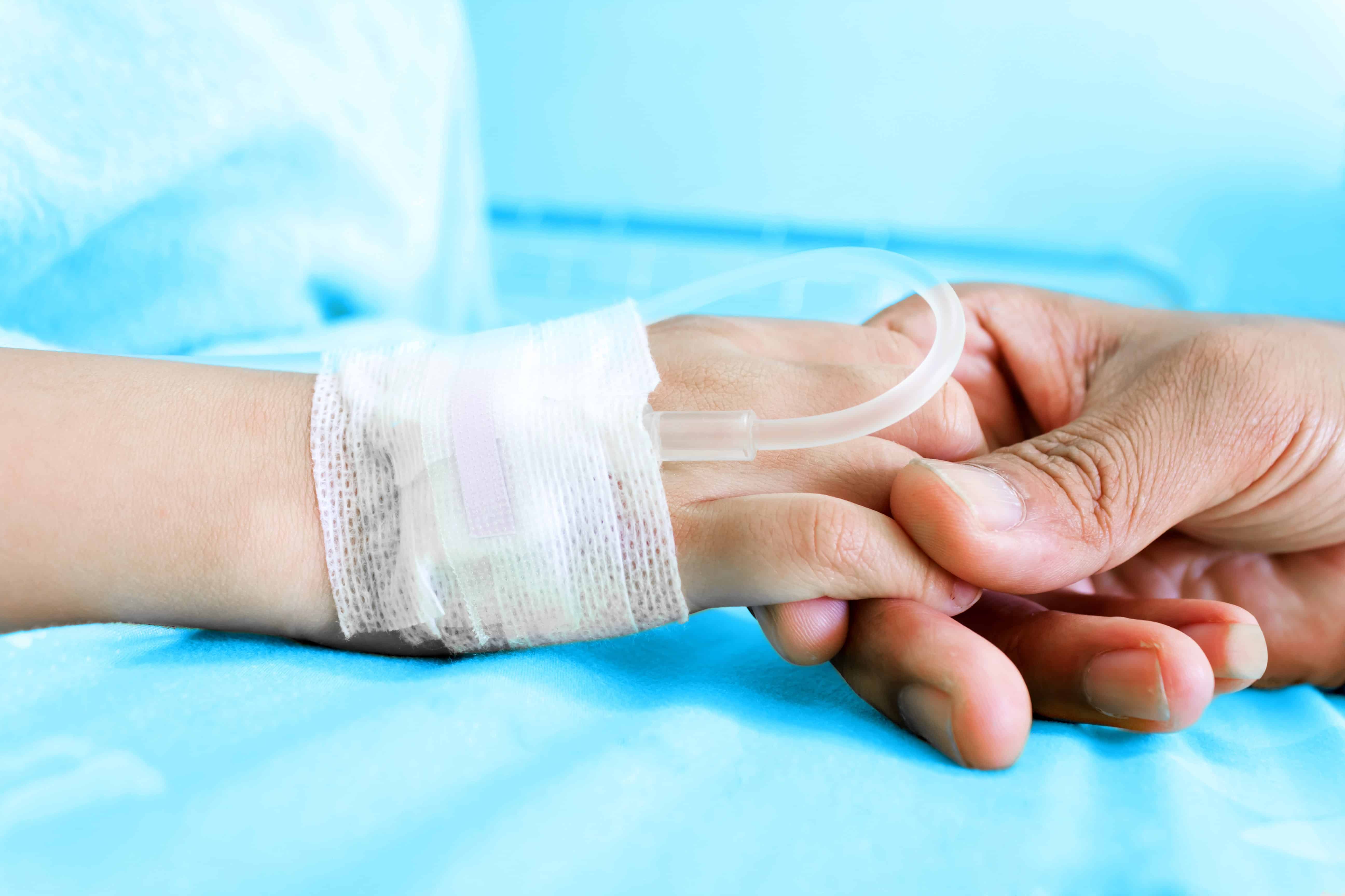 A child patient's hand with an IV solution