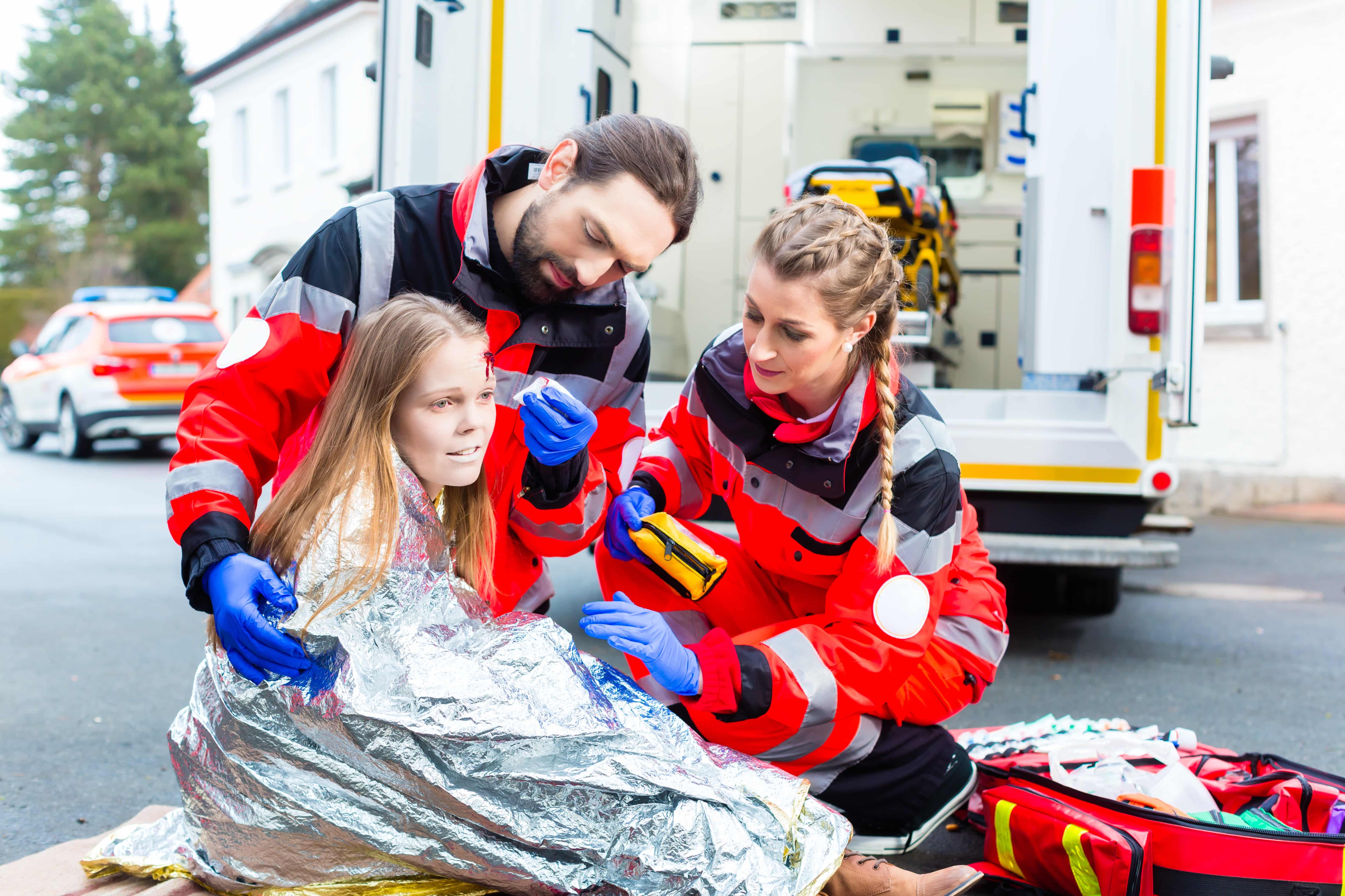 EMS professionals tending to a young girl