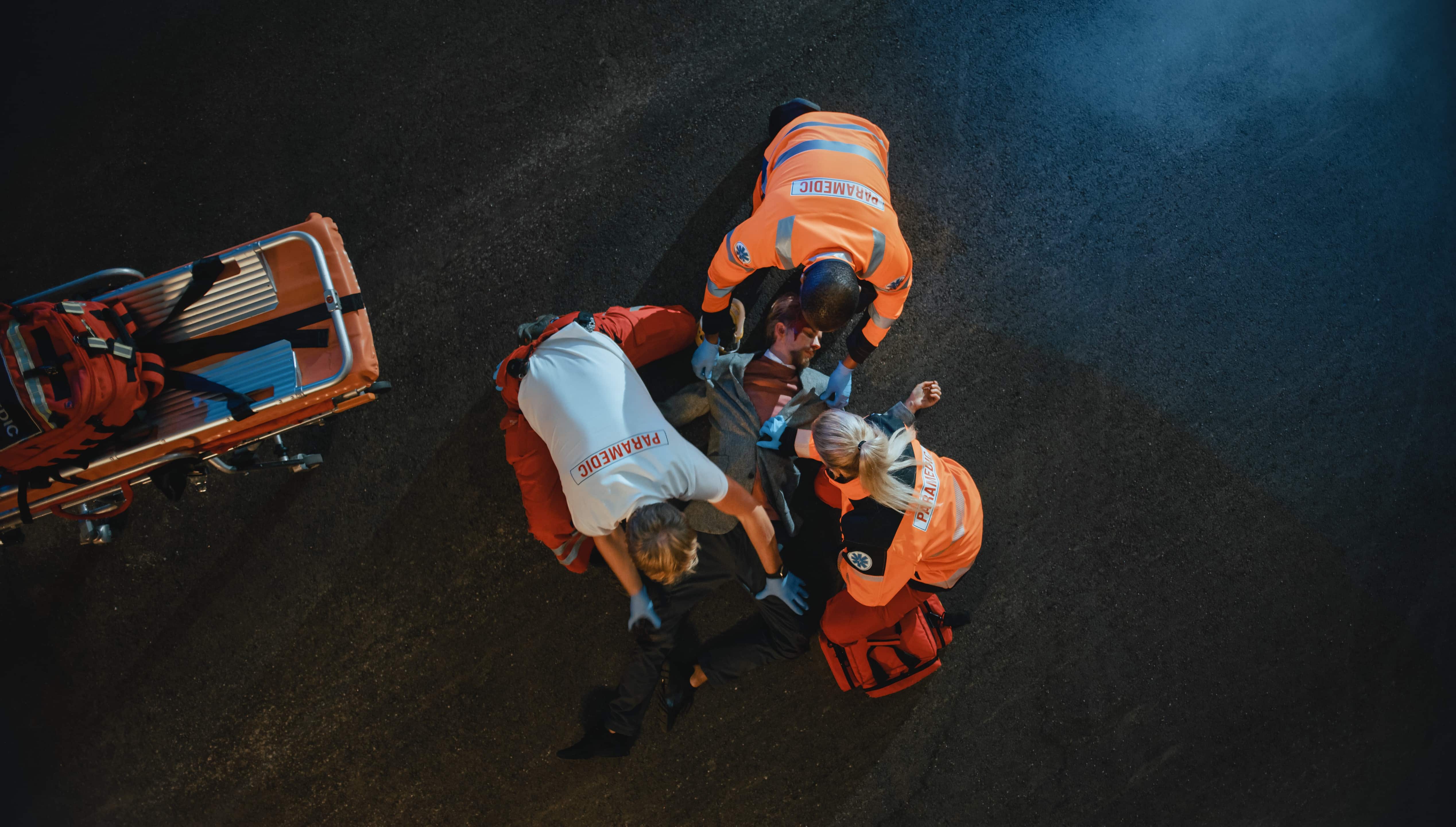 Aerial view of paramedics rescuing a man on the street