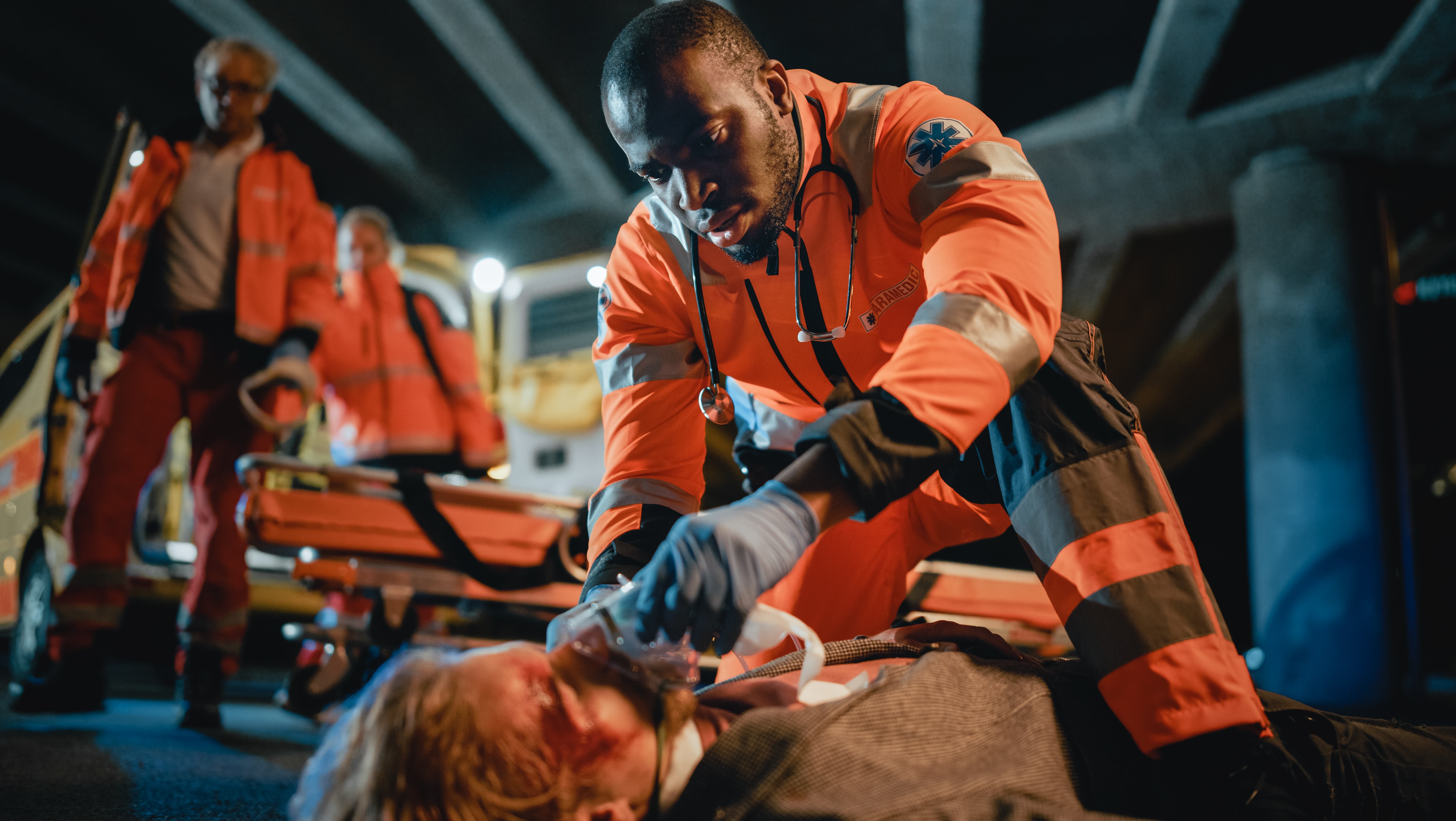 African-American paramedic applying oxygen to a man's face