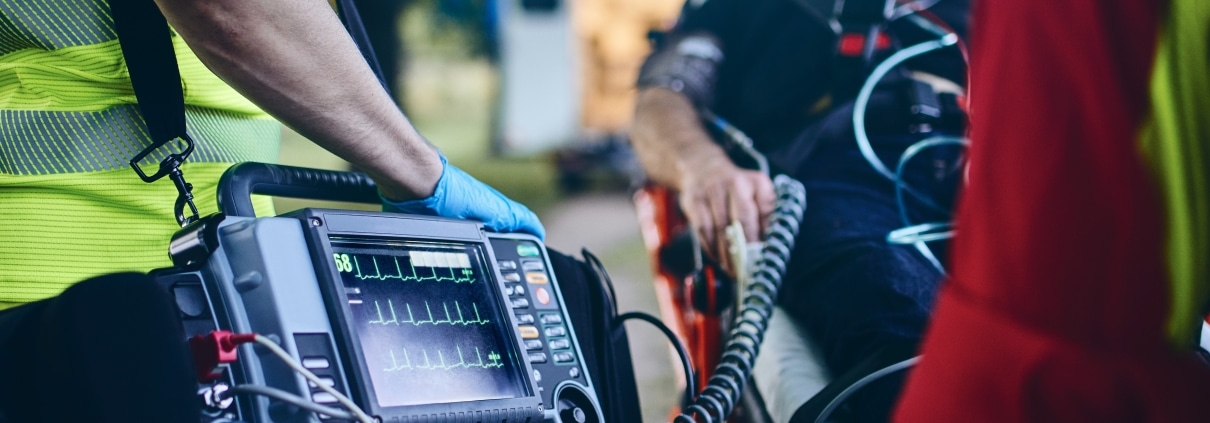 EMS professionals monitoring a man's vitals