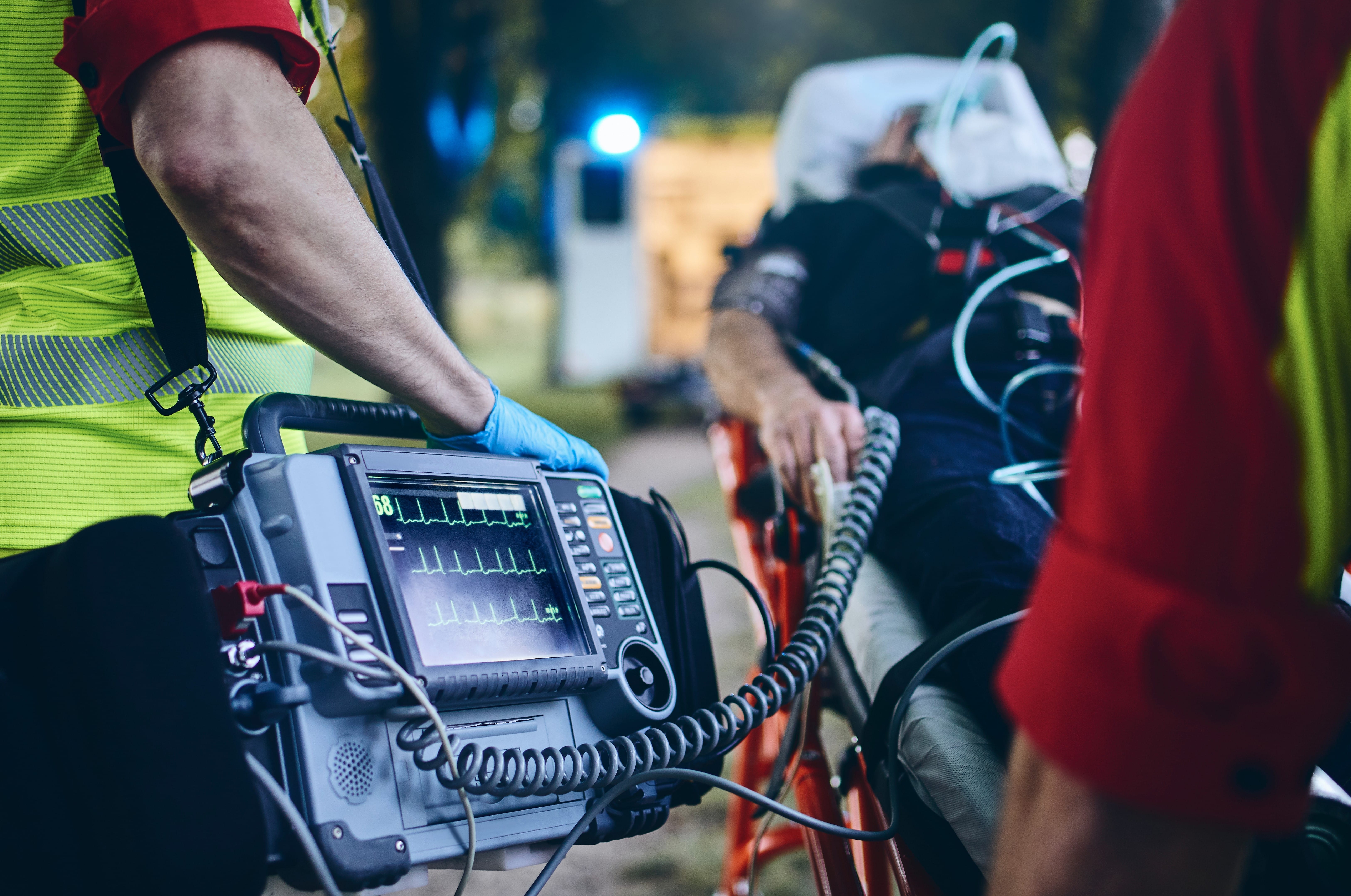 EMS professionals monitoring a man's vitals