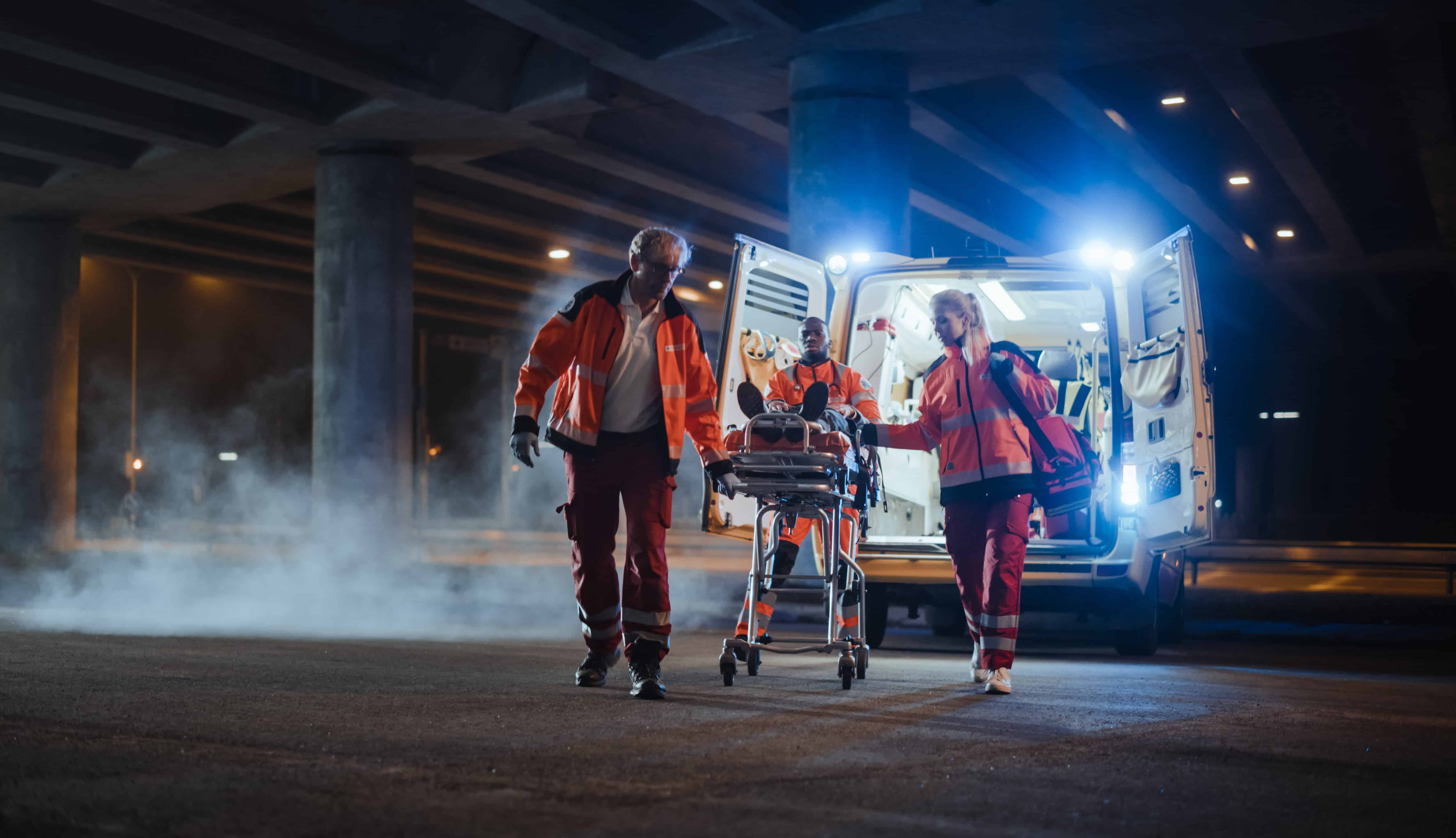 EMS professionals transporting a person on a stretcher