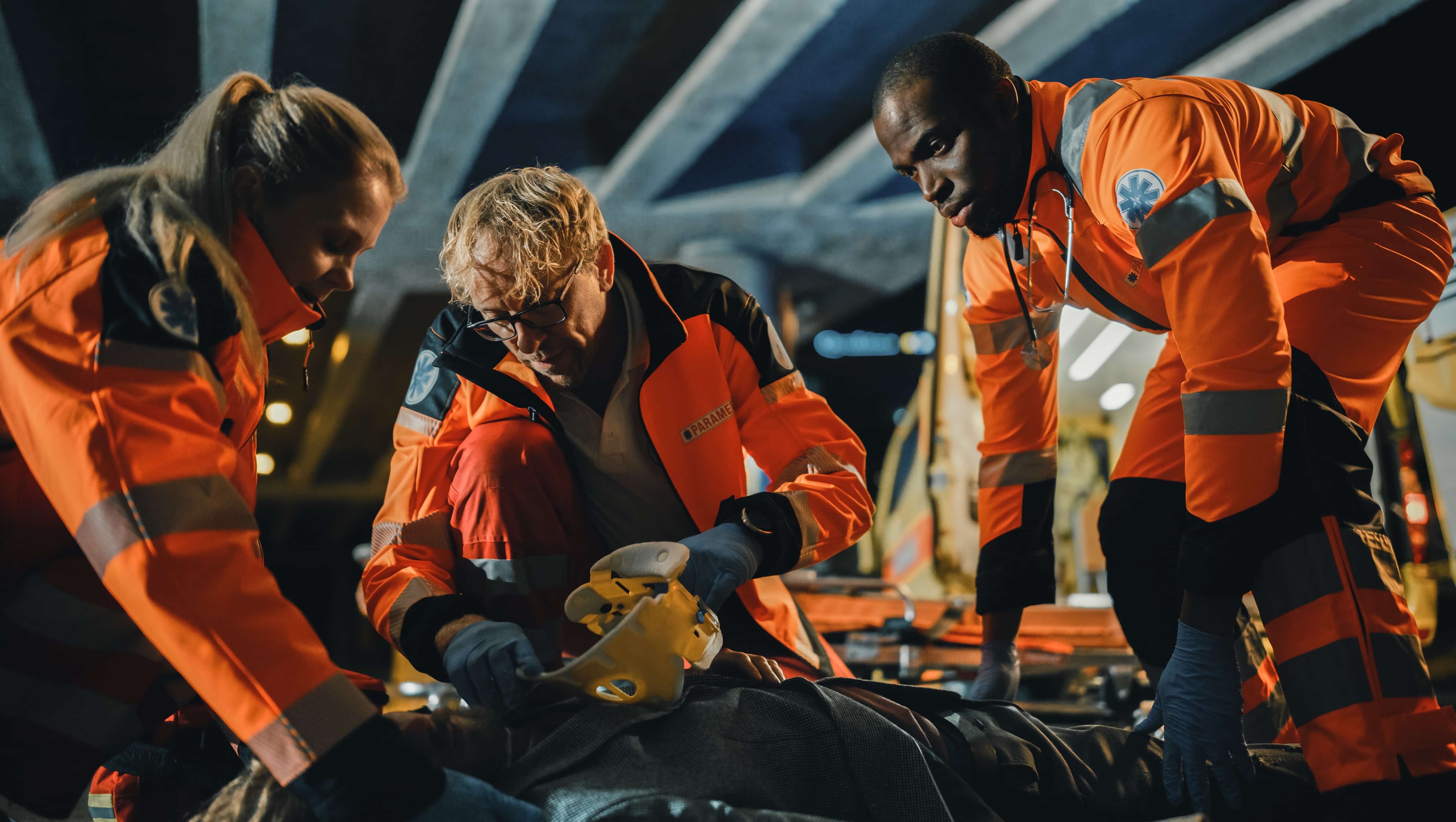 EMS professionals helping a man on the ground