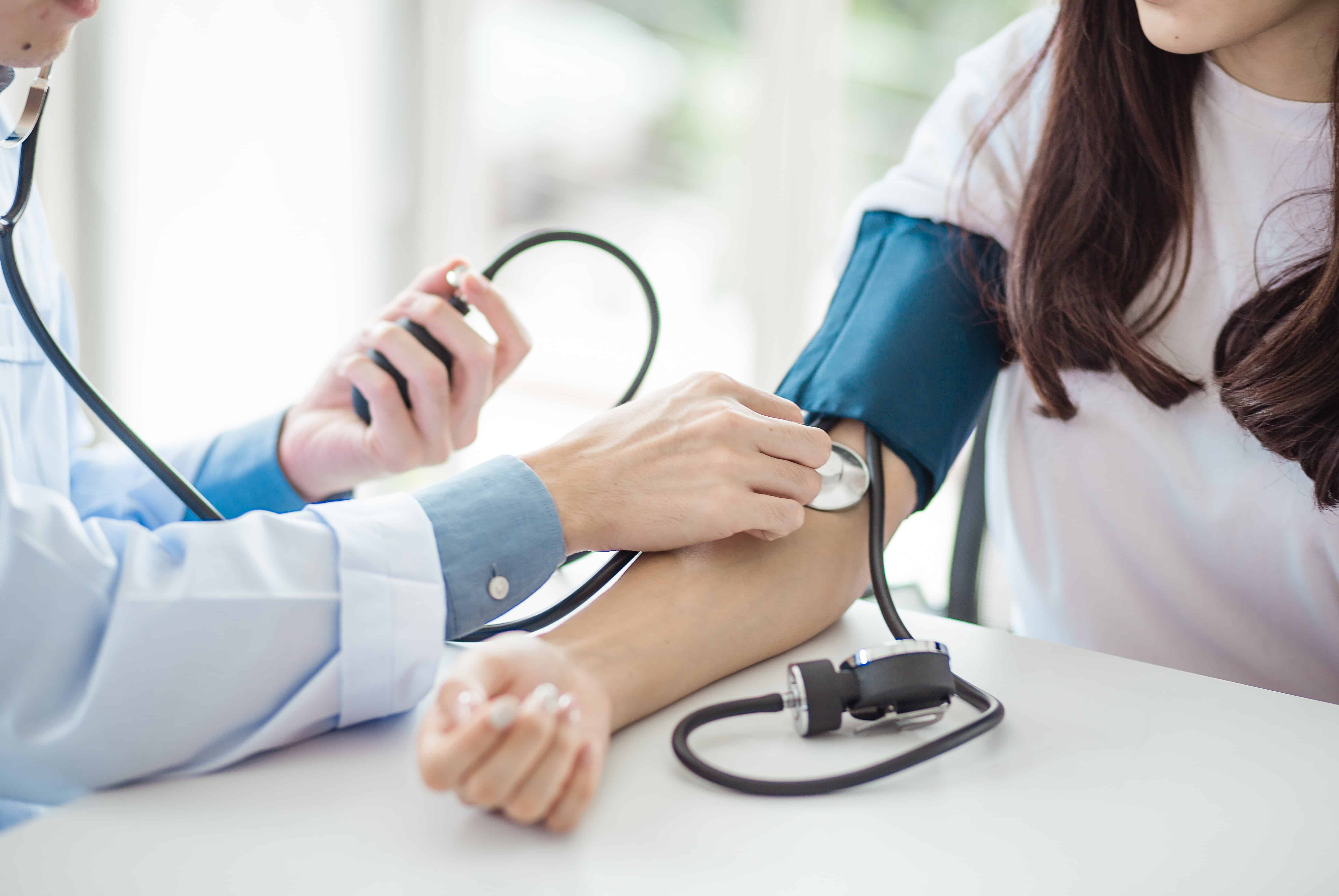Medical professional using a blood pressure cuff
