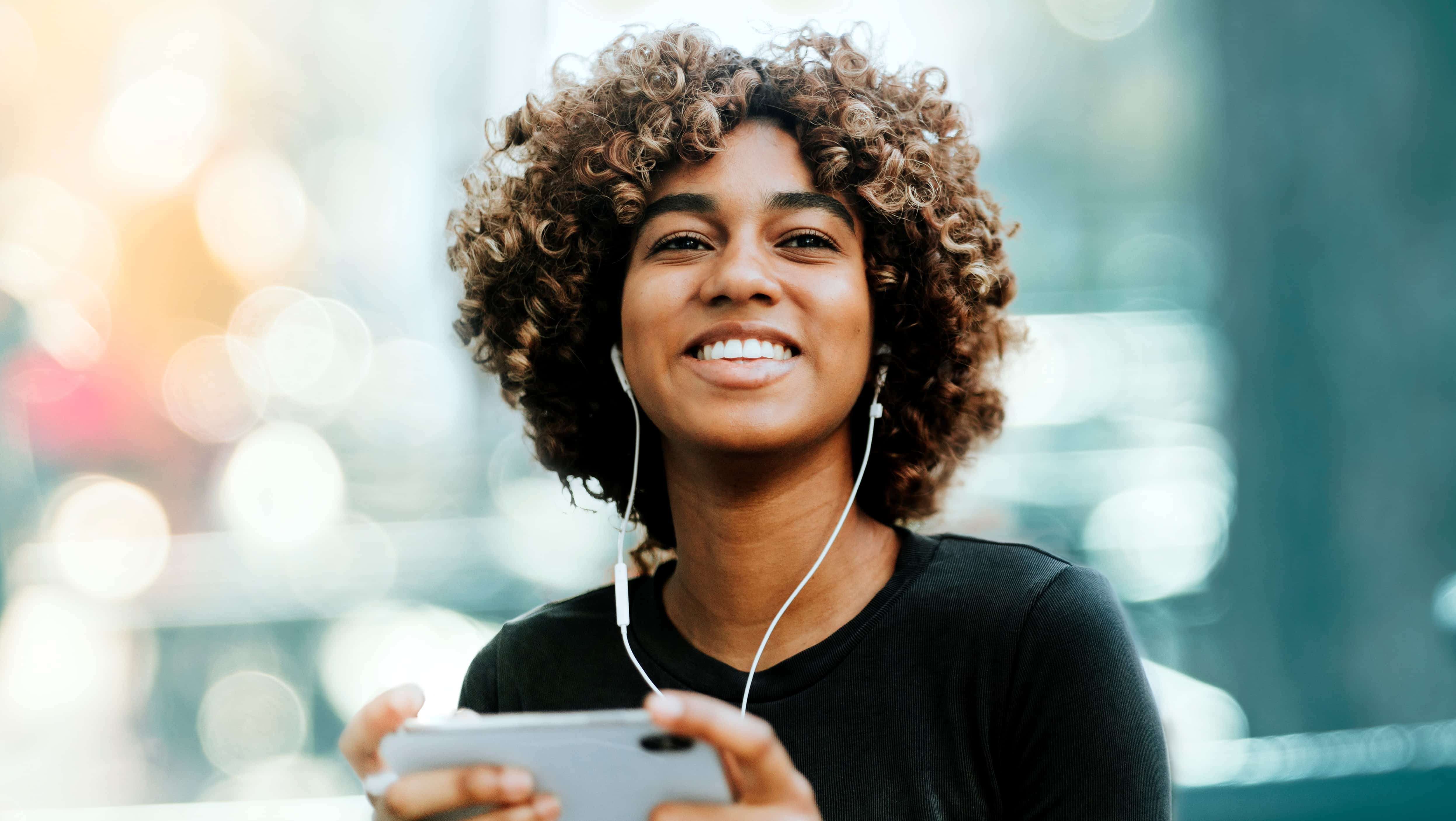 Smiling African-American woman wearing headphones