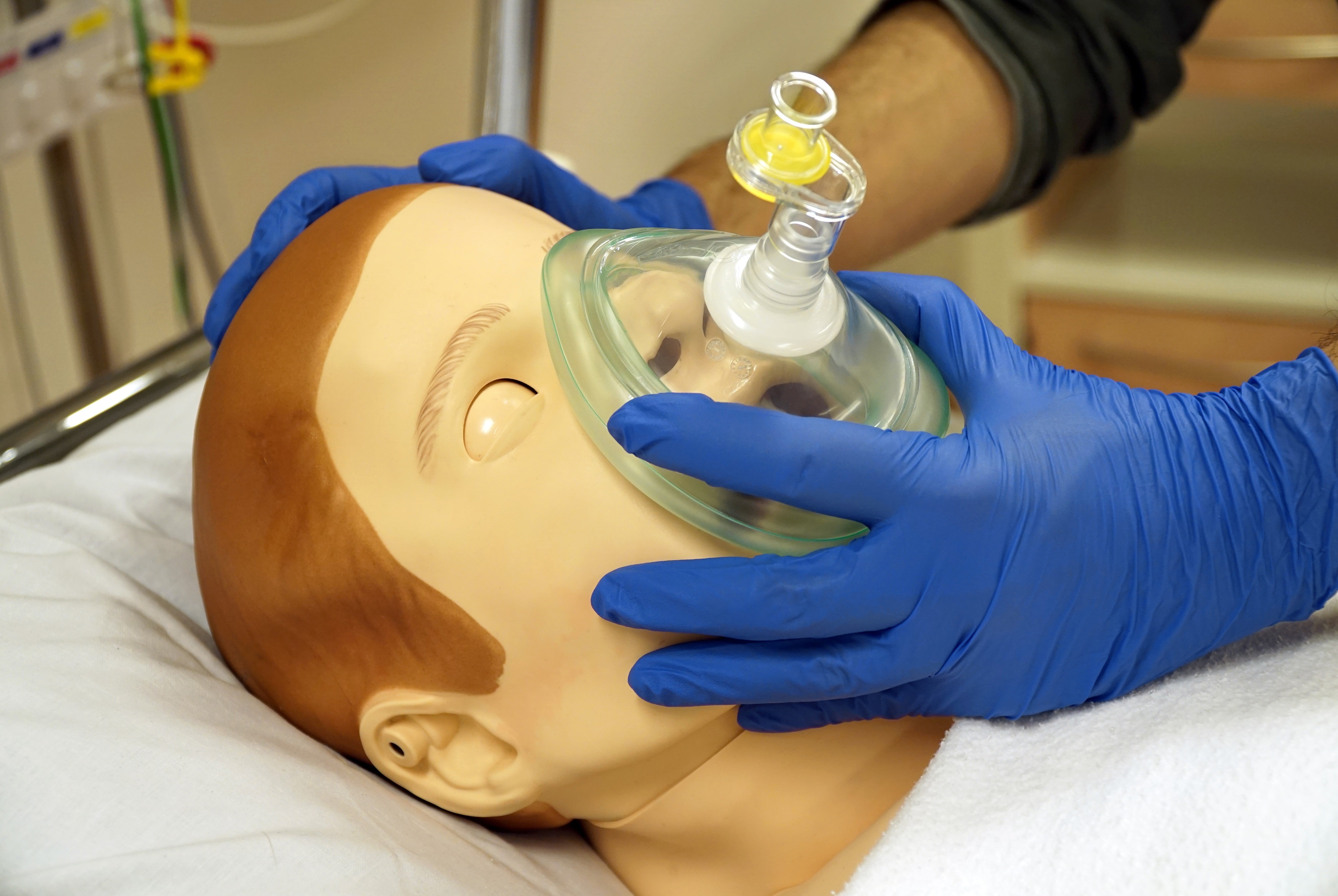 Medical instructor using a Pocket Mask with a One-Way Valve on a mannequin