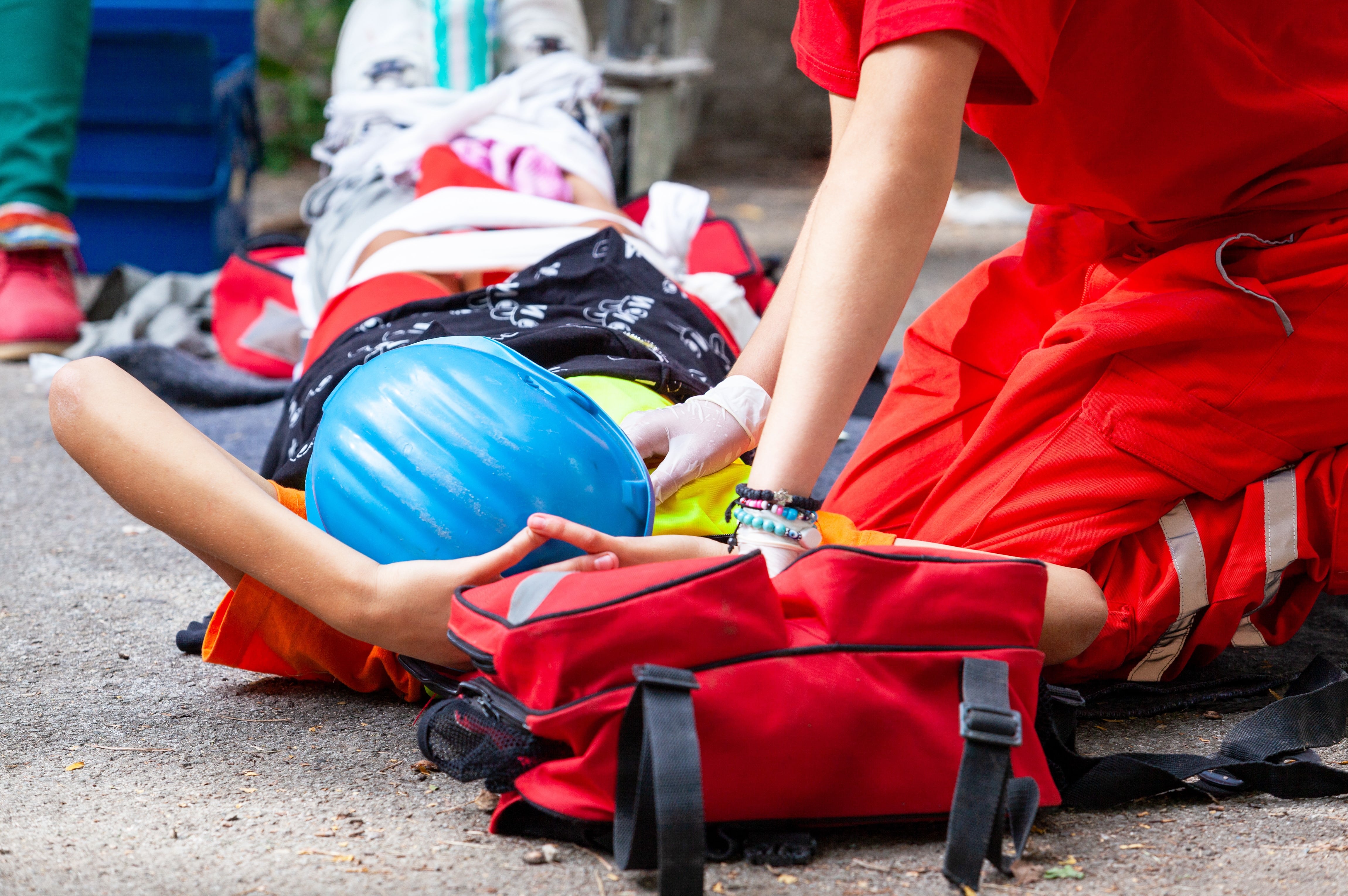 EMS professional treating a person on a stretcher
