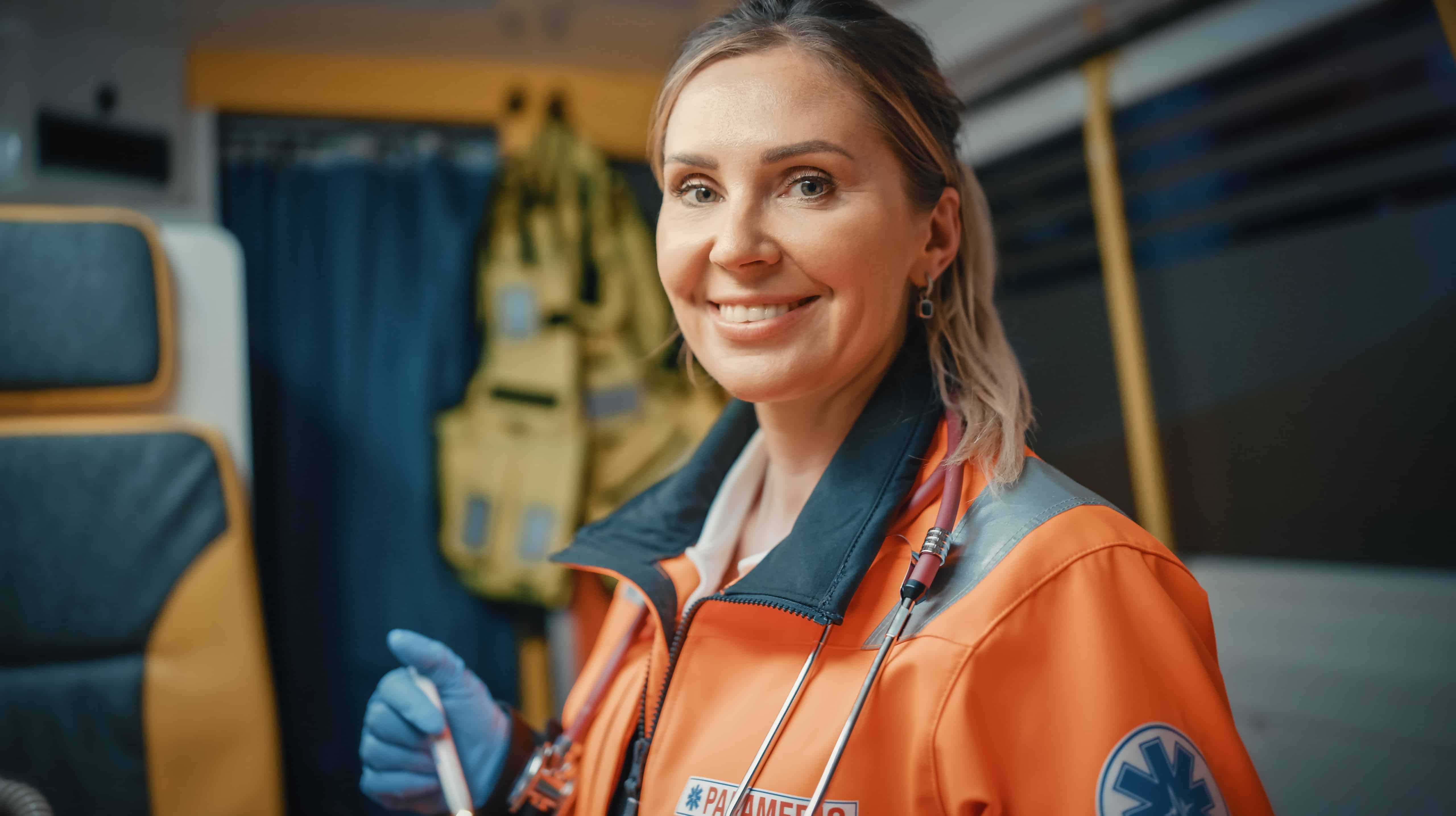 Smiling EMS professional in an ambulance