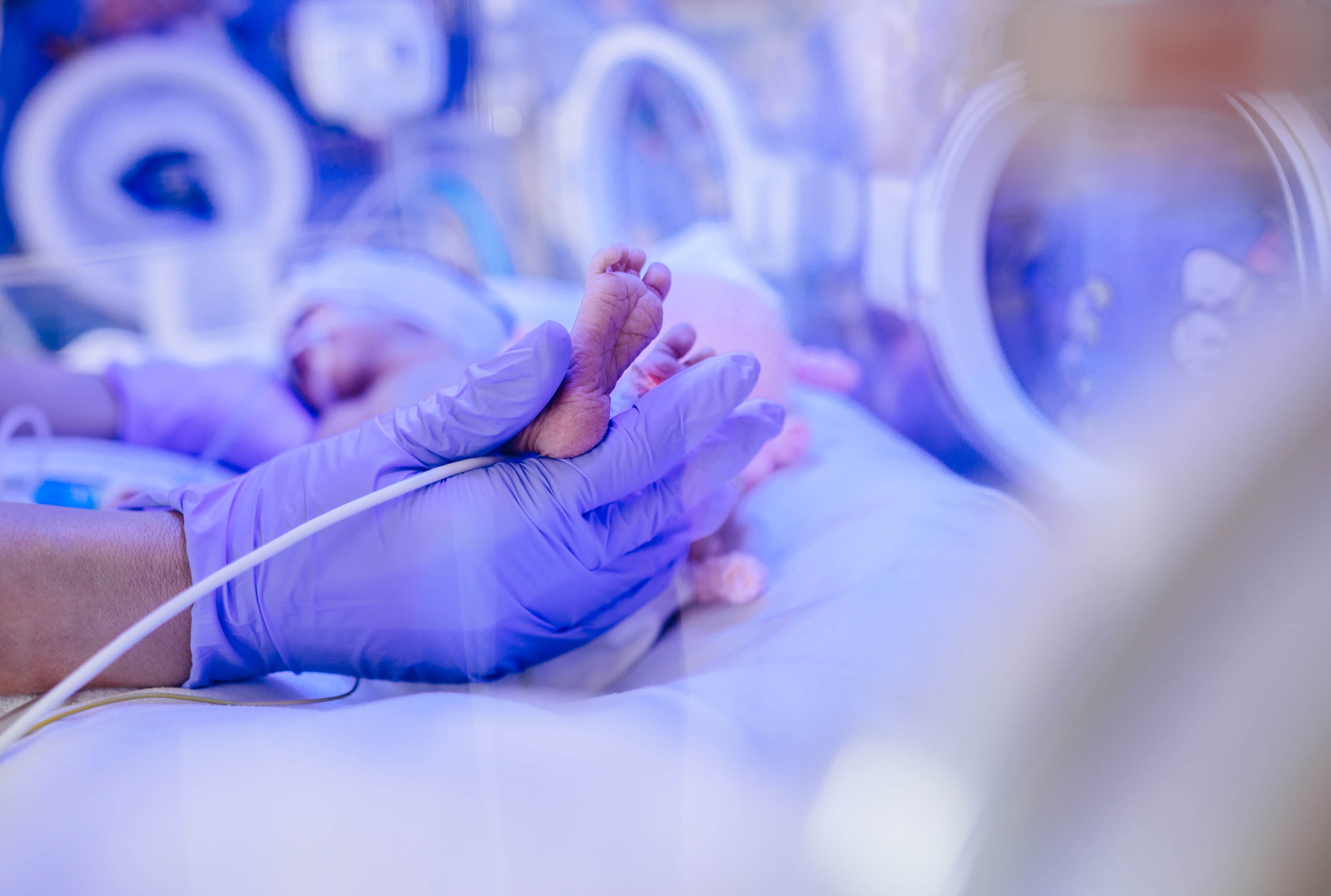 Close up of a medical professional holding an infant's foot
