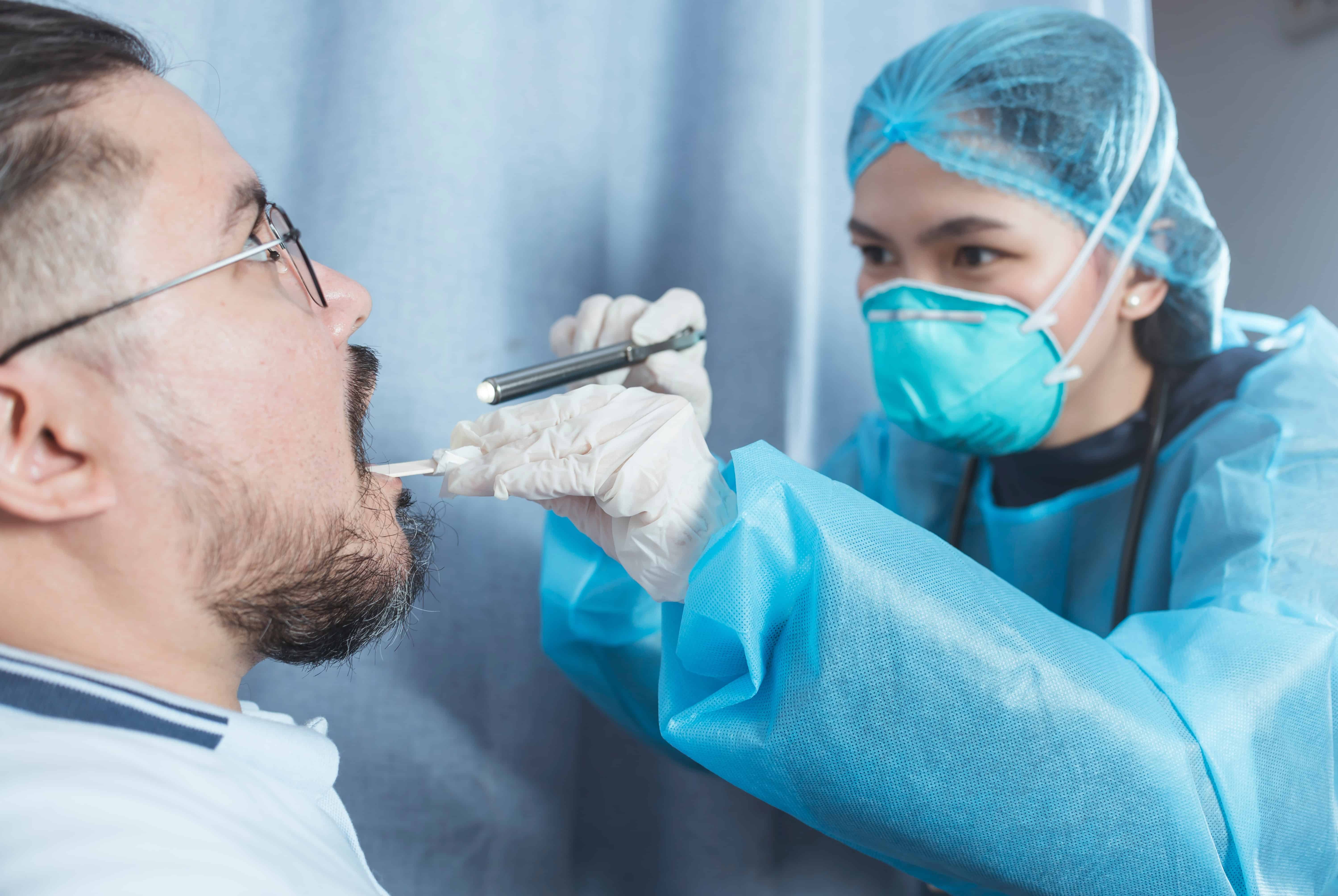 Medical professional in protective gear using a Diagnostic Pen