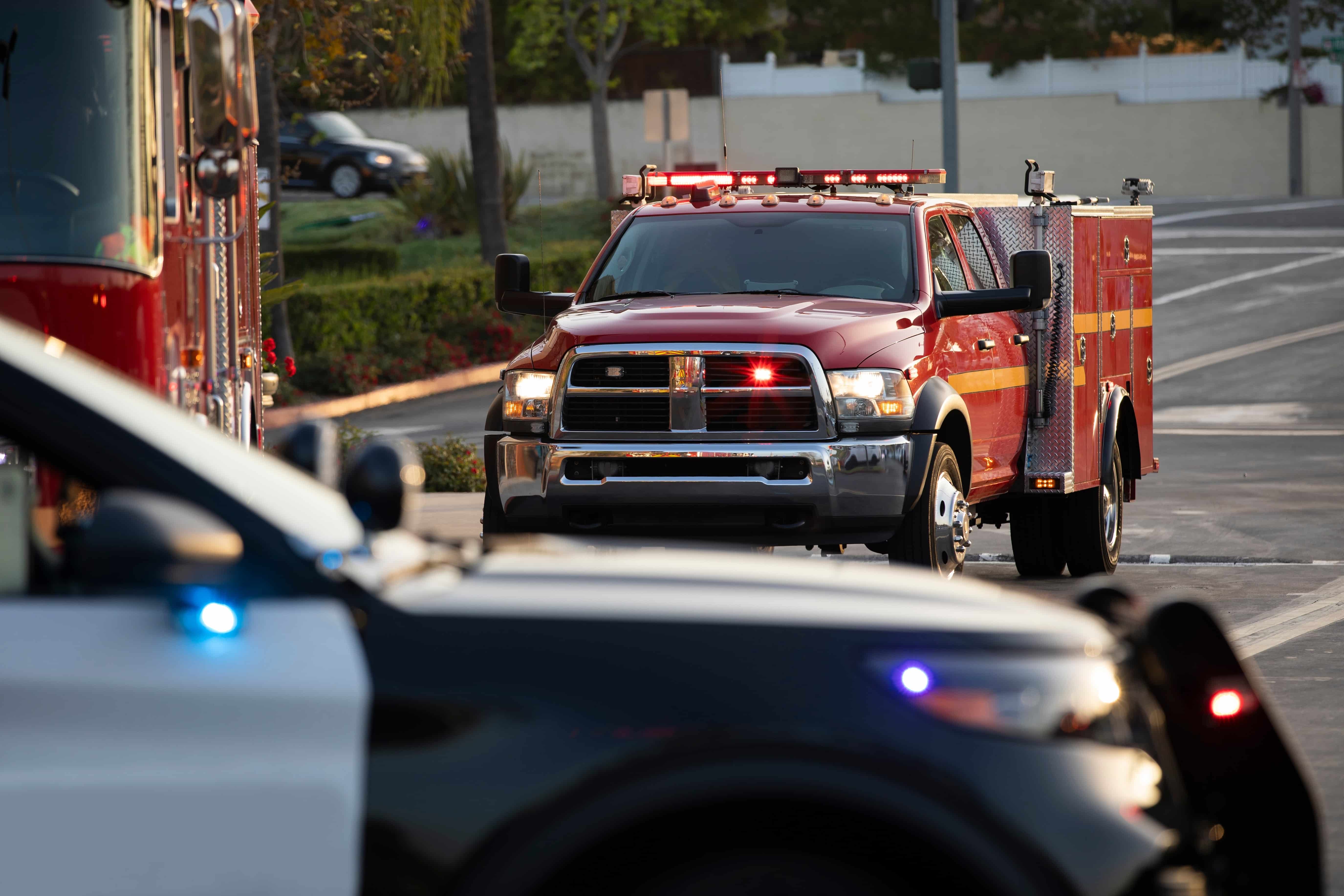 Close up of an ambulance, fire engine, and police car