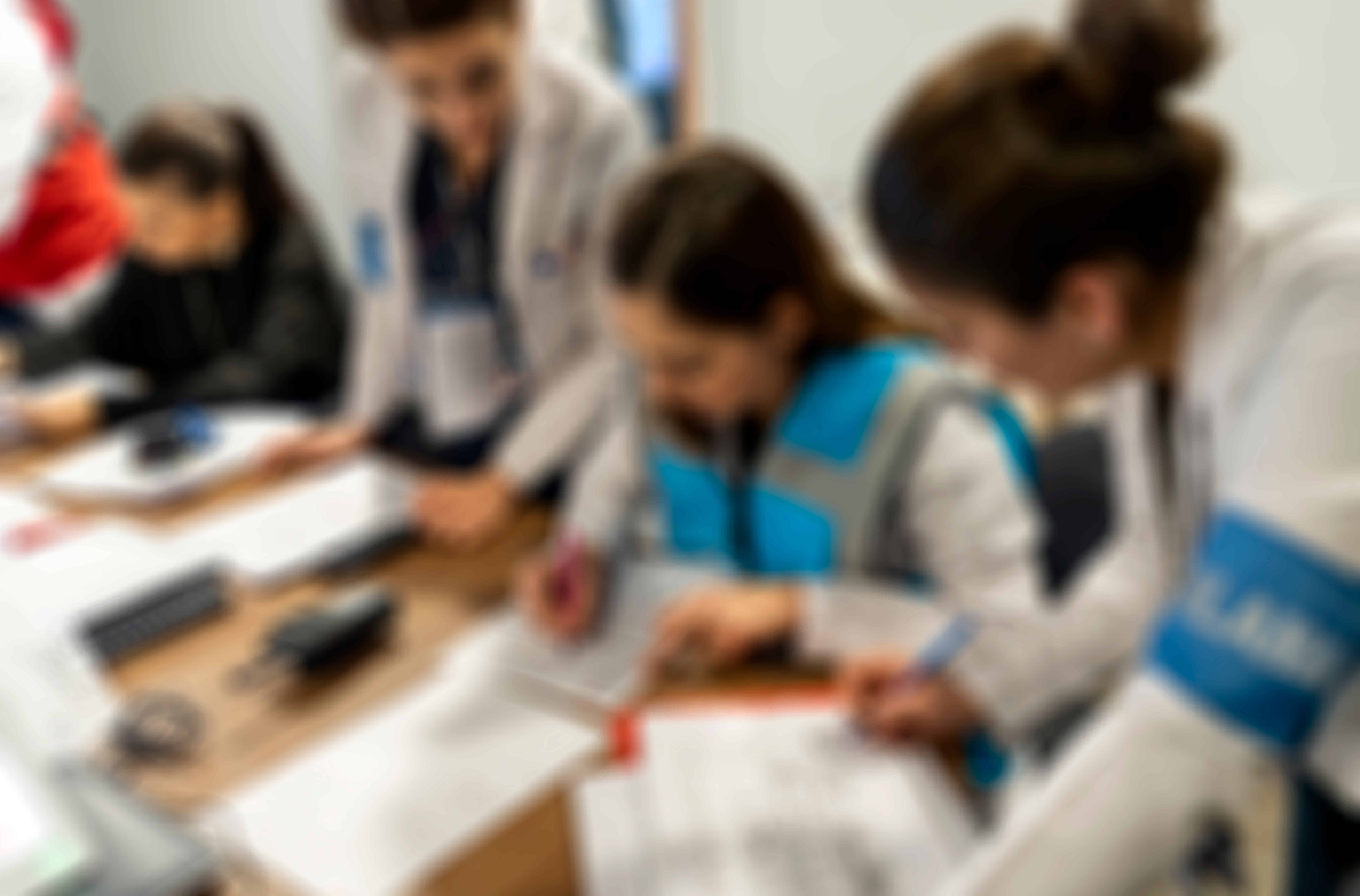 Blurred image of search and rescue teams sitting around a table