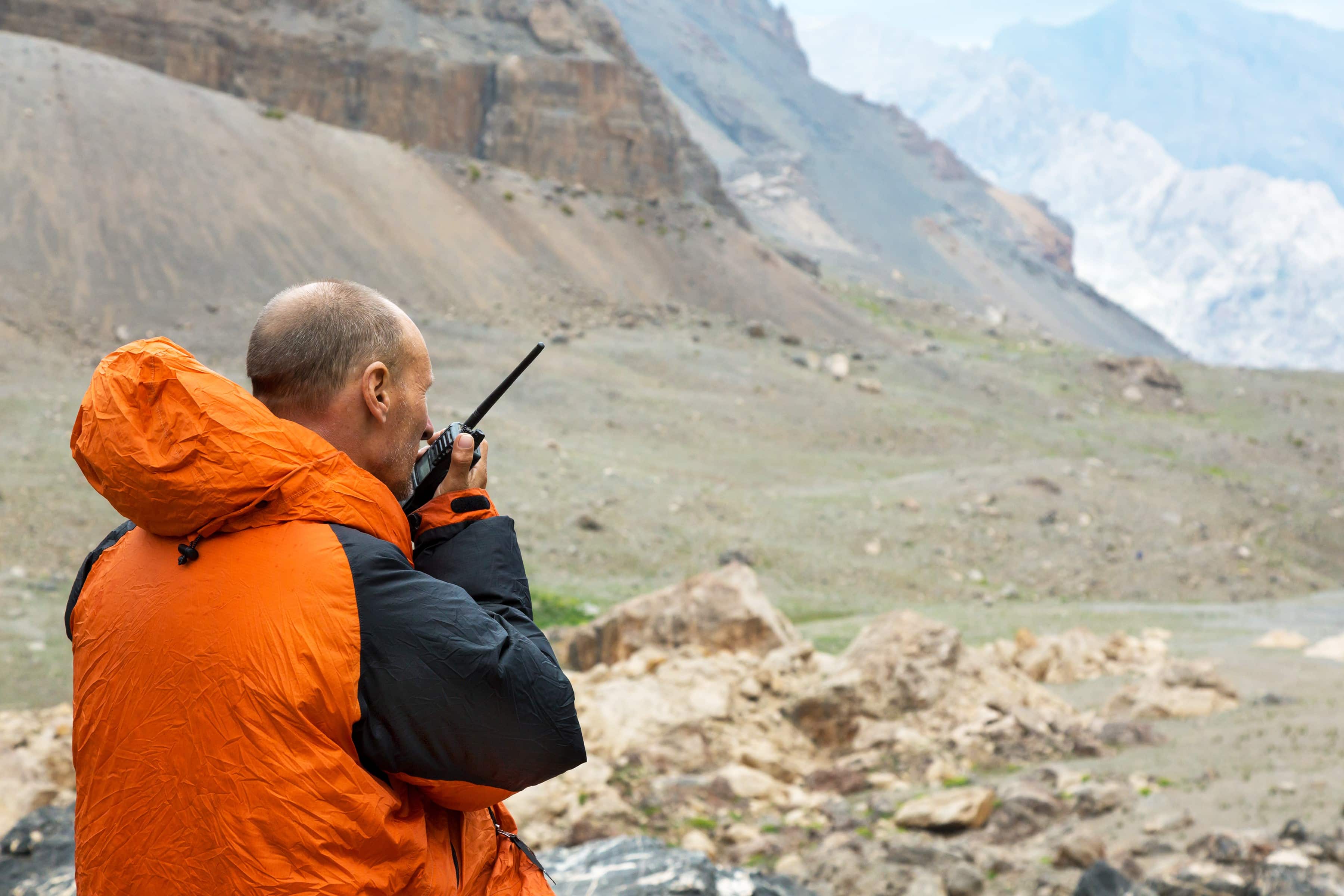 Man speaking on a radio in the wilderness