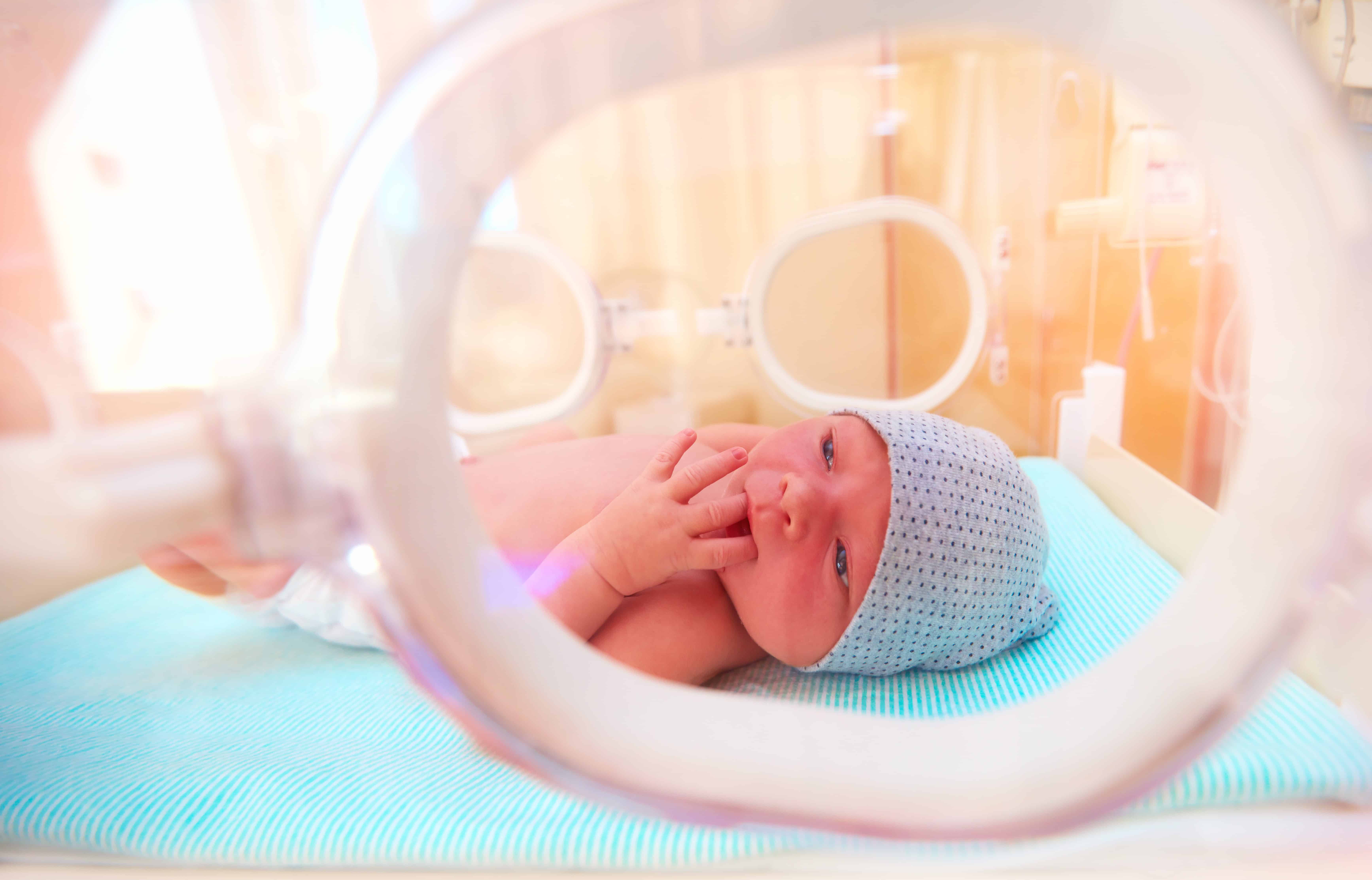 Close up of an infant in a neonatal unit