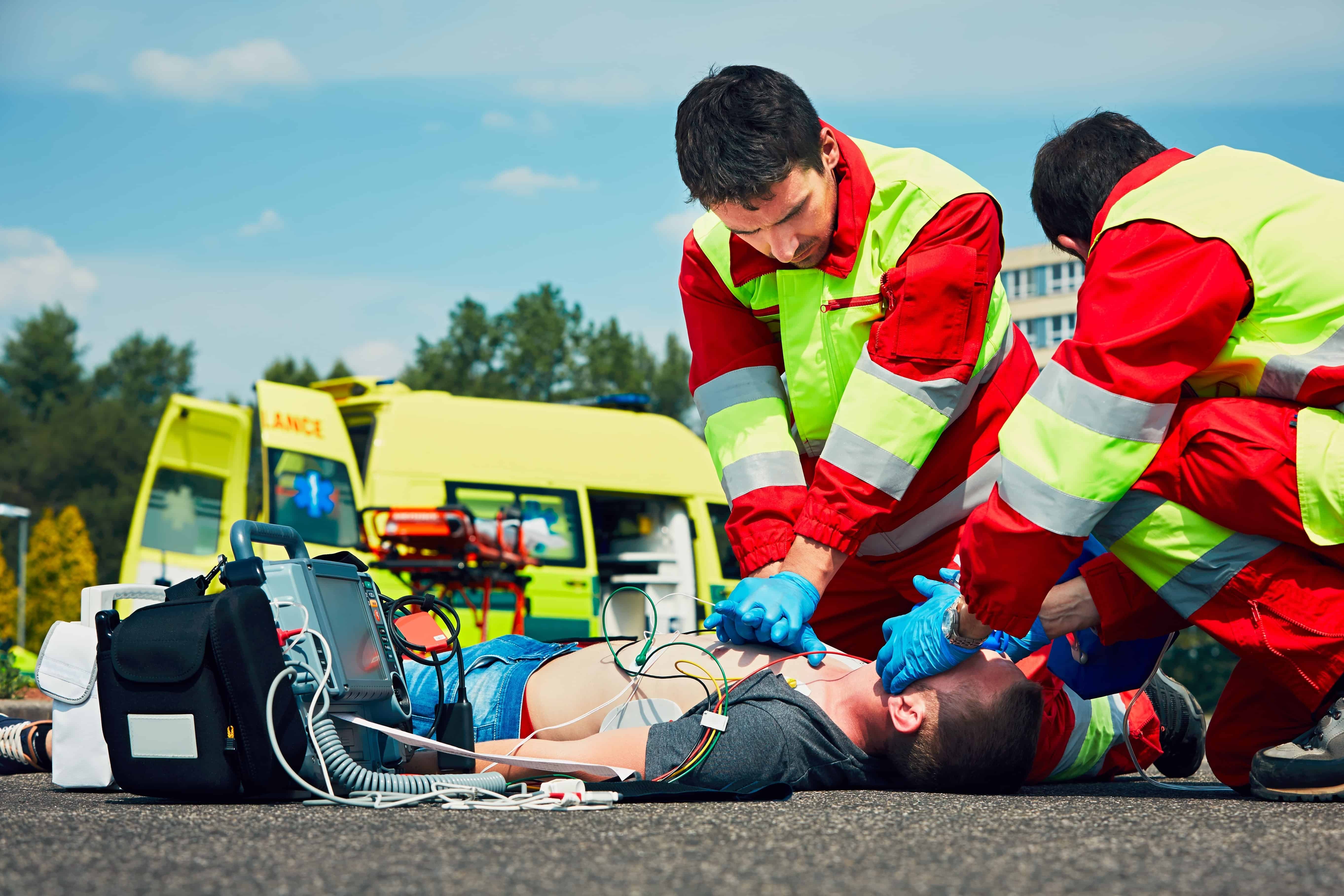 EMS team performing CPR on a man outside