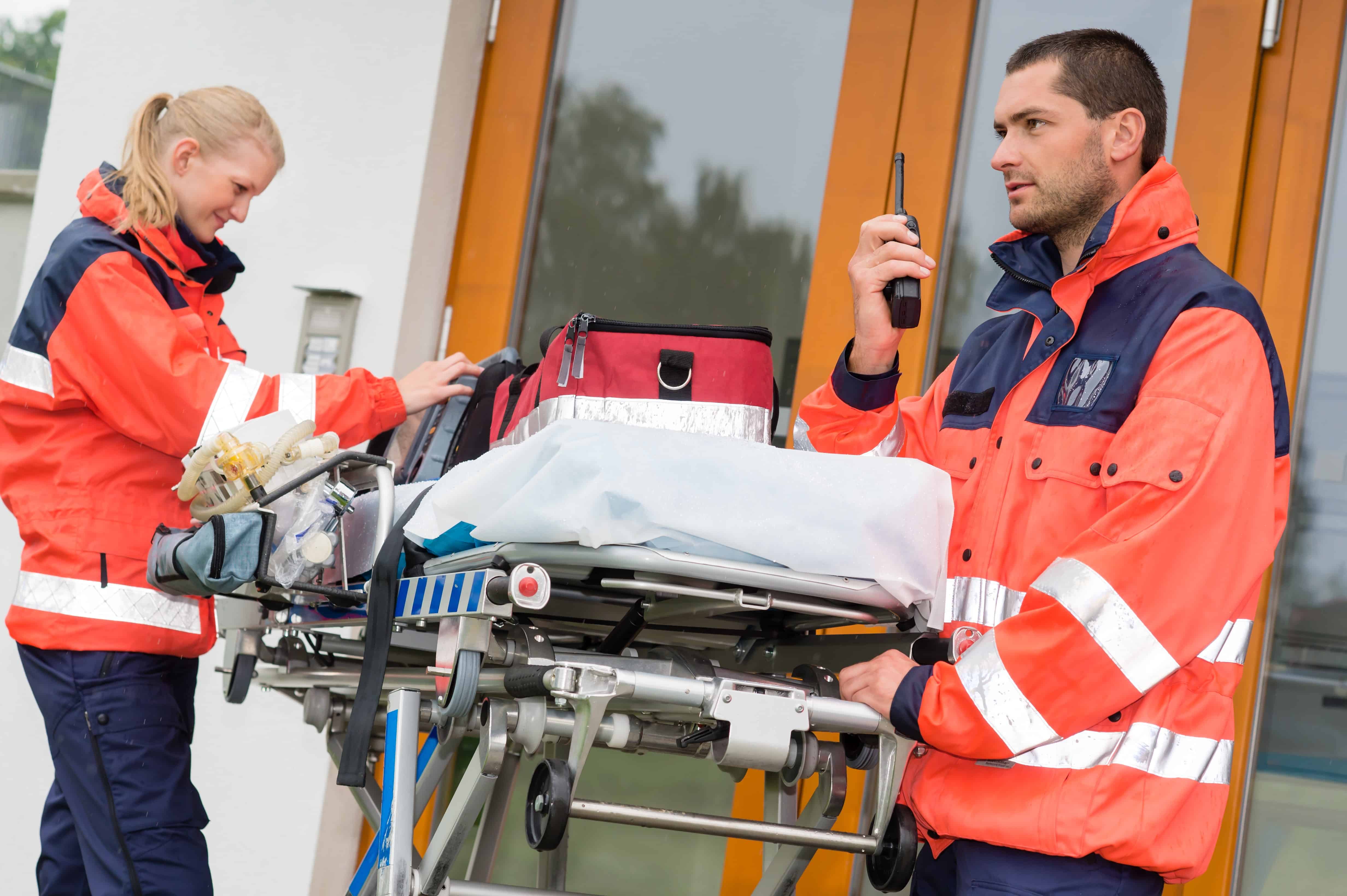 Two EMS professionals transporting a stretcher