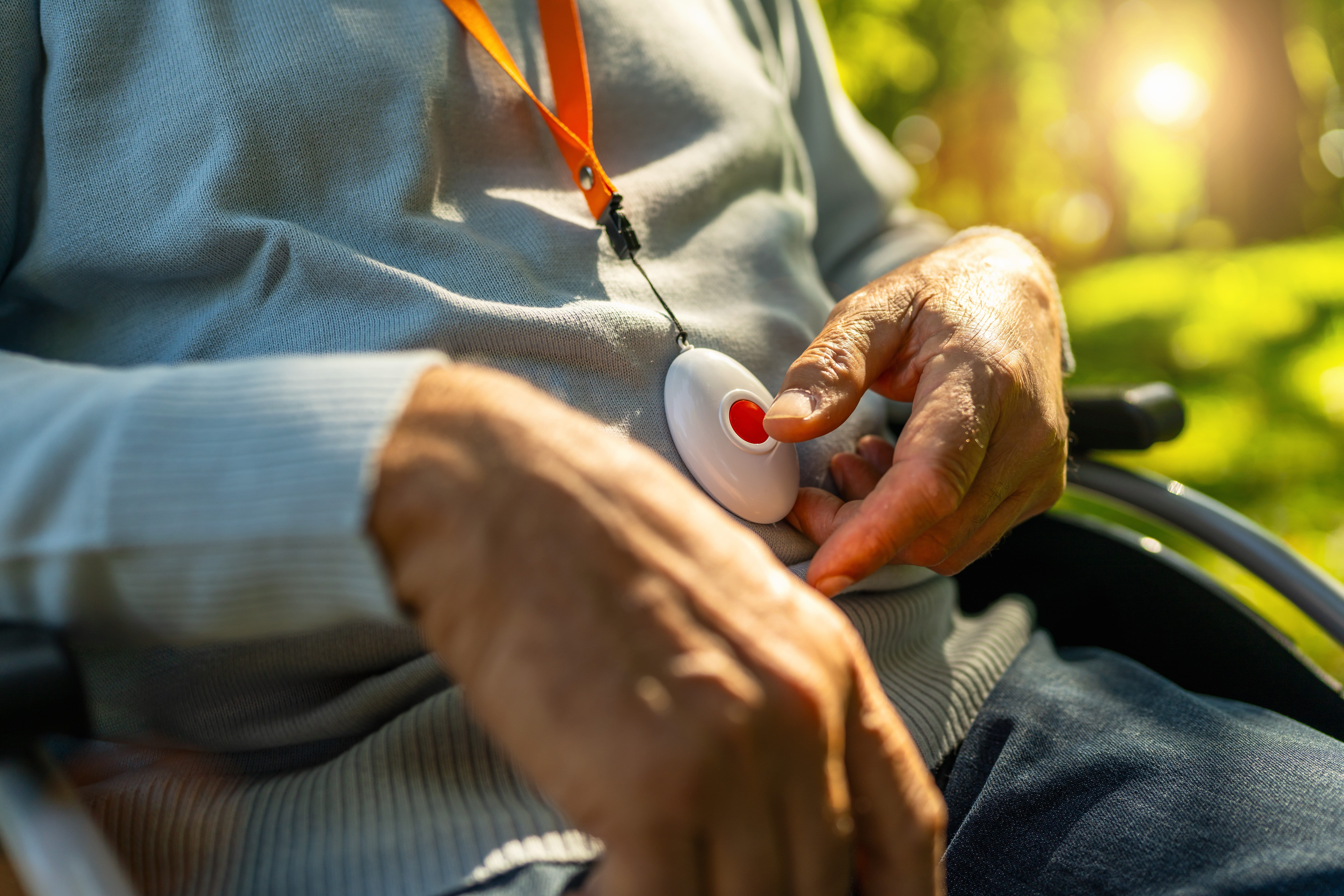 Close up of an elderly person with a medical alert necklace