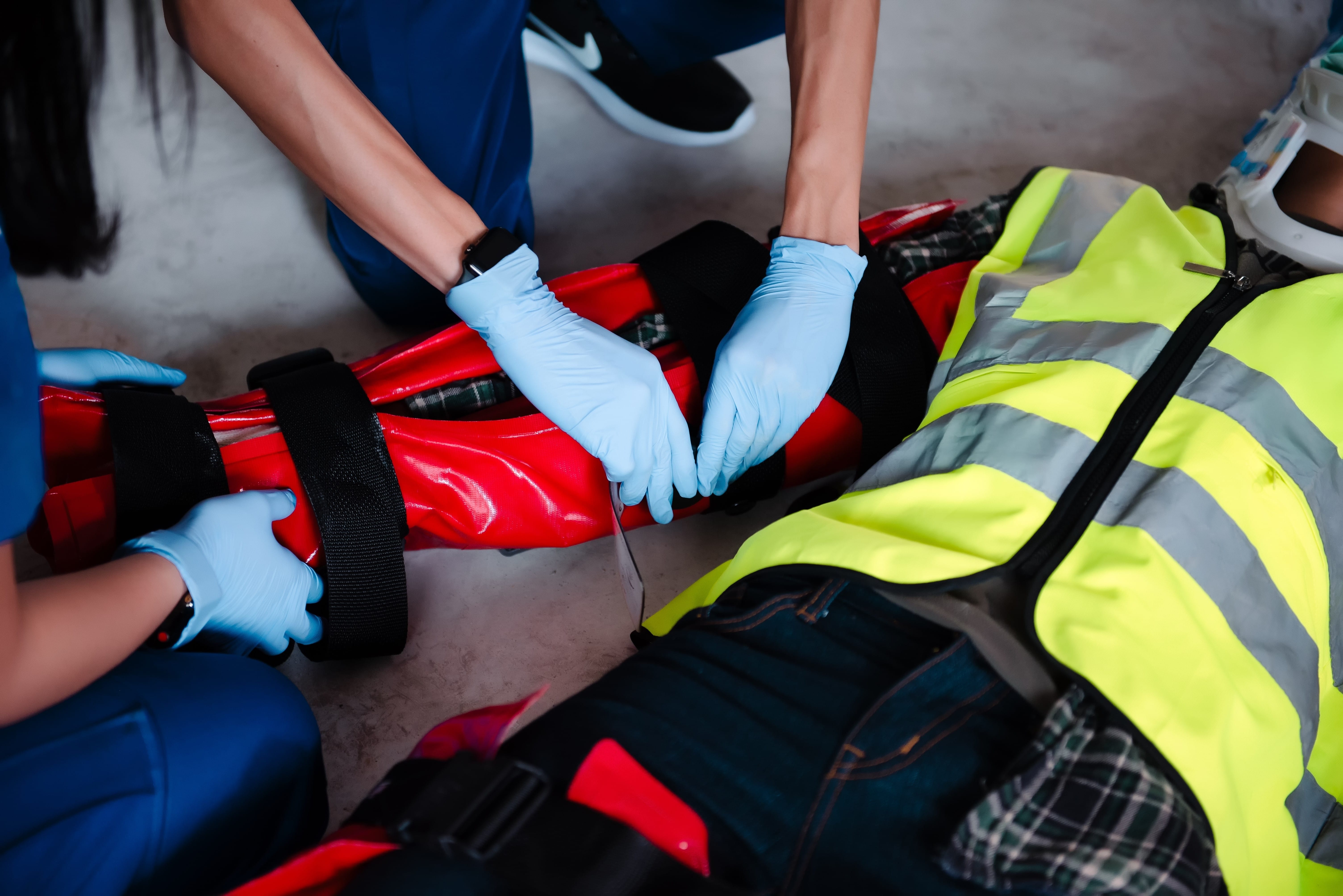 Close up of an EMS team treating an industrial worker