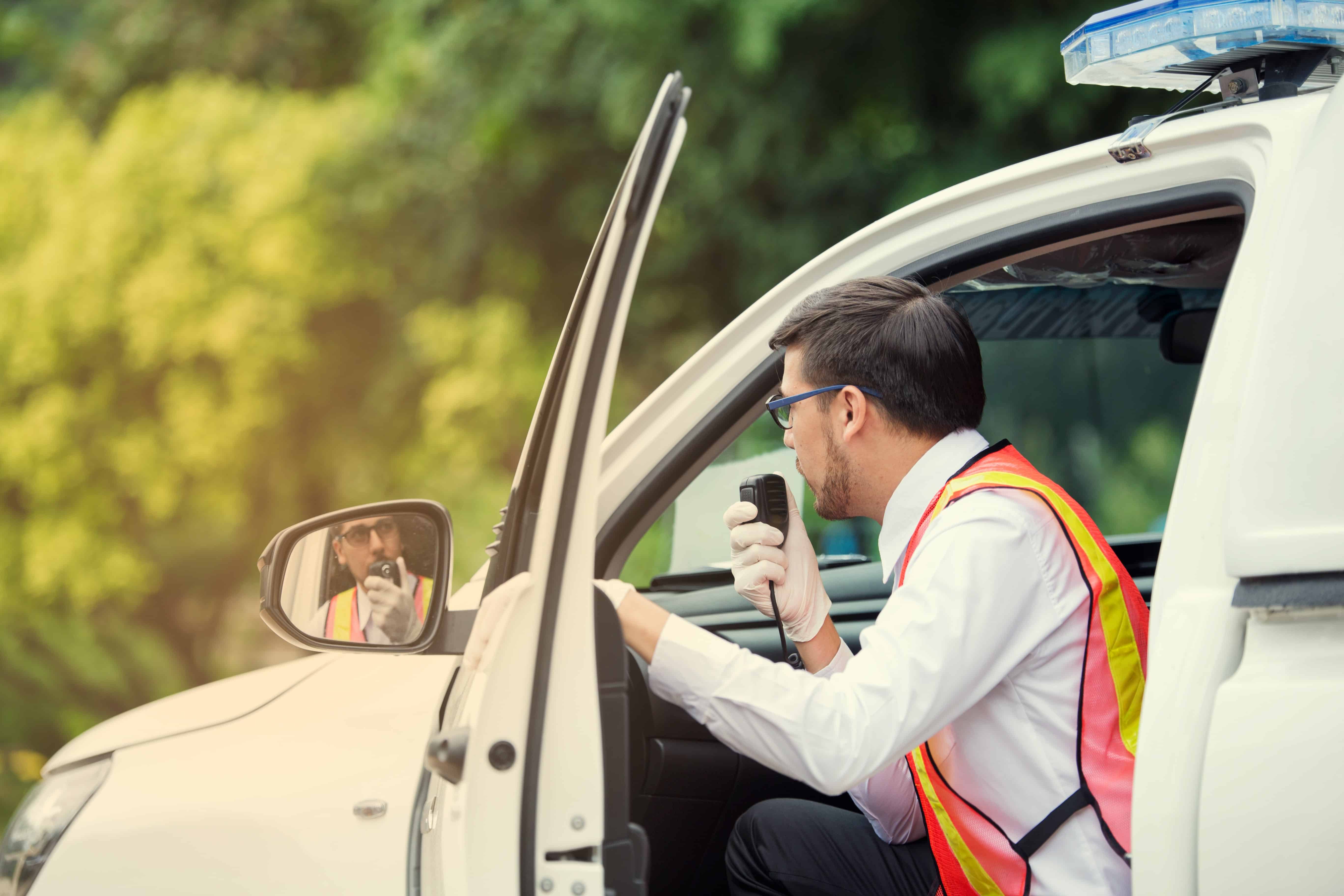 Industrial EMT using a radio in an ambulance