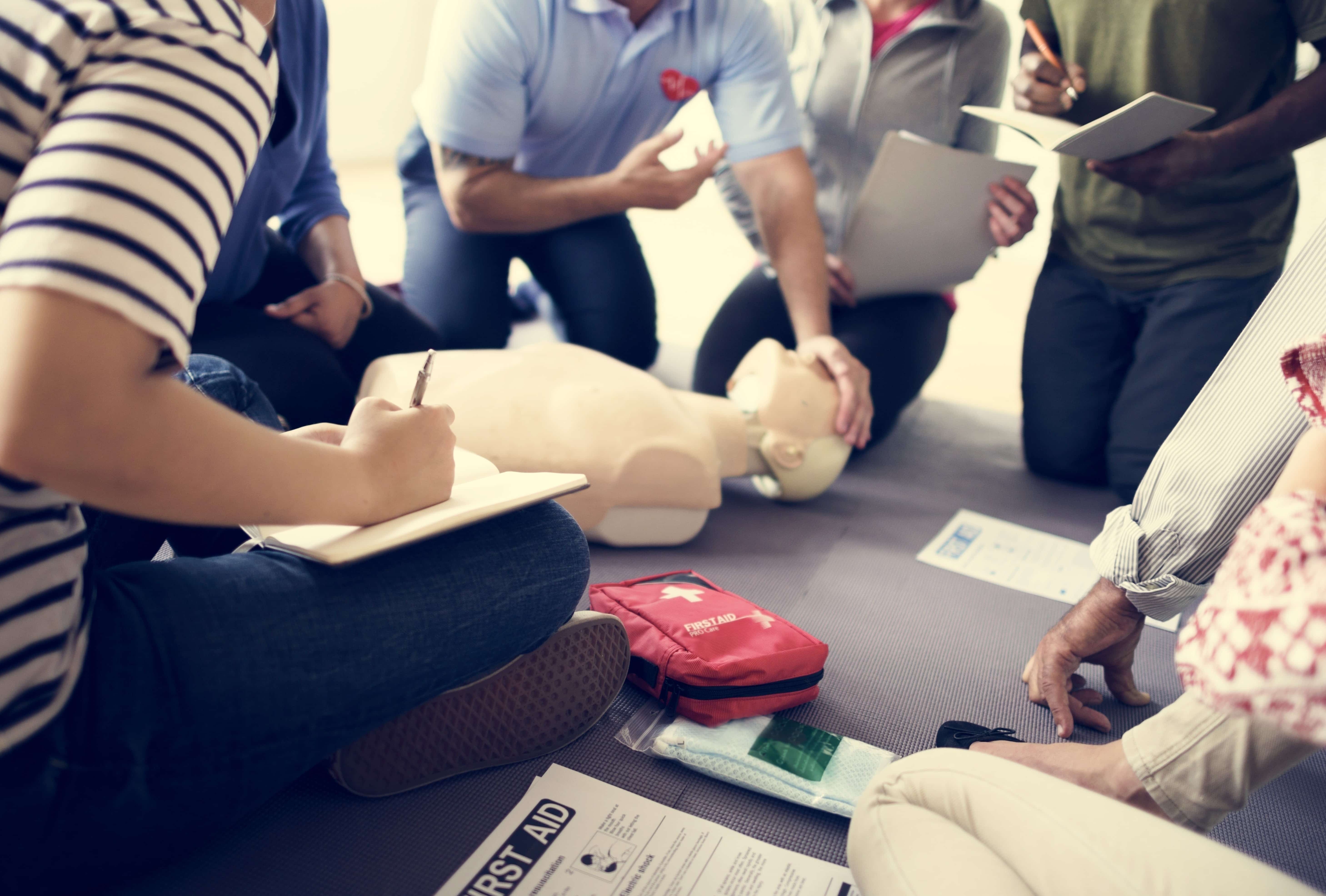 Students practicing CPR on a medical mannequin