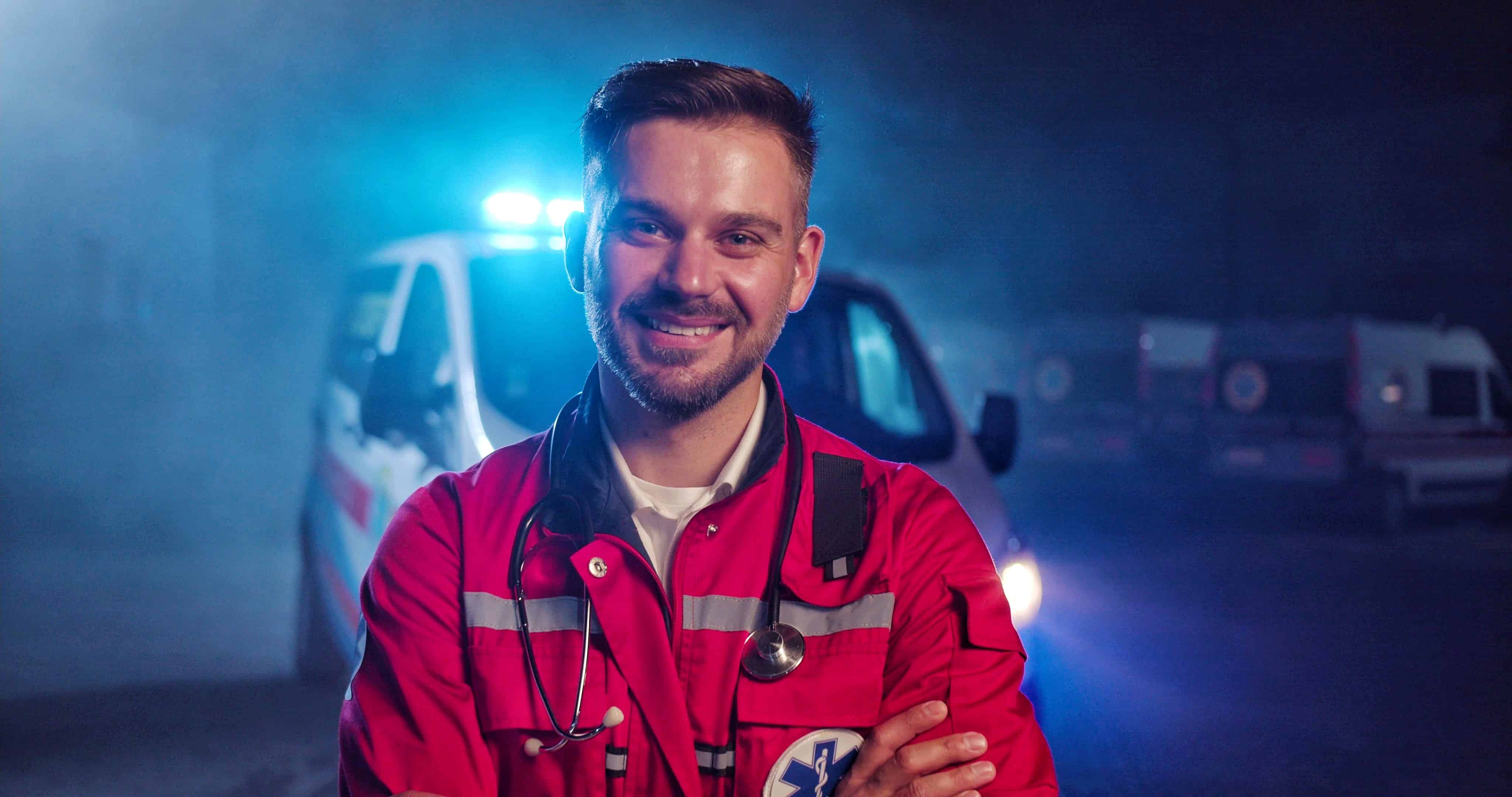 Smiling EMS professional standing outside