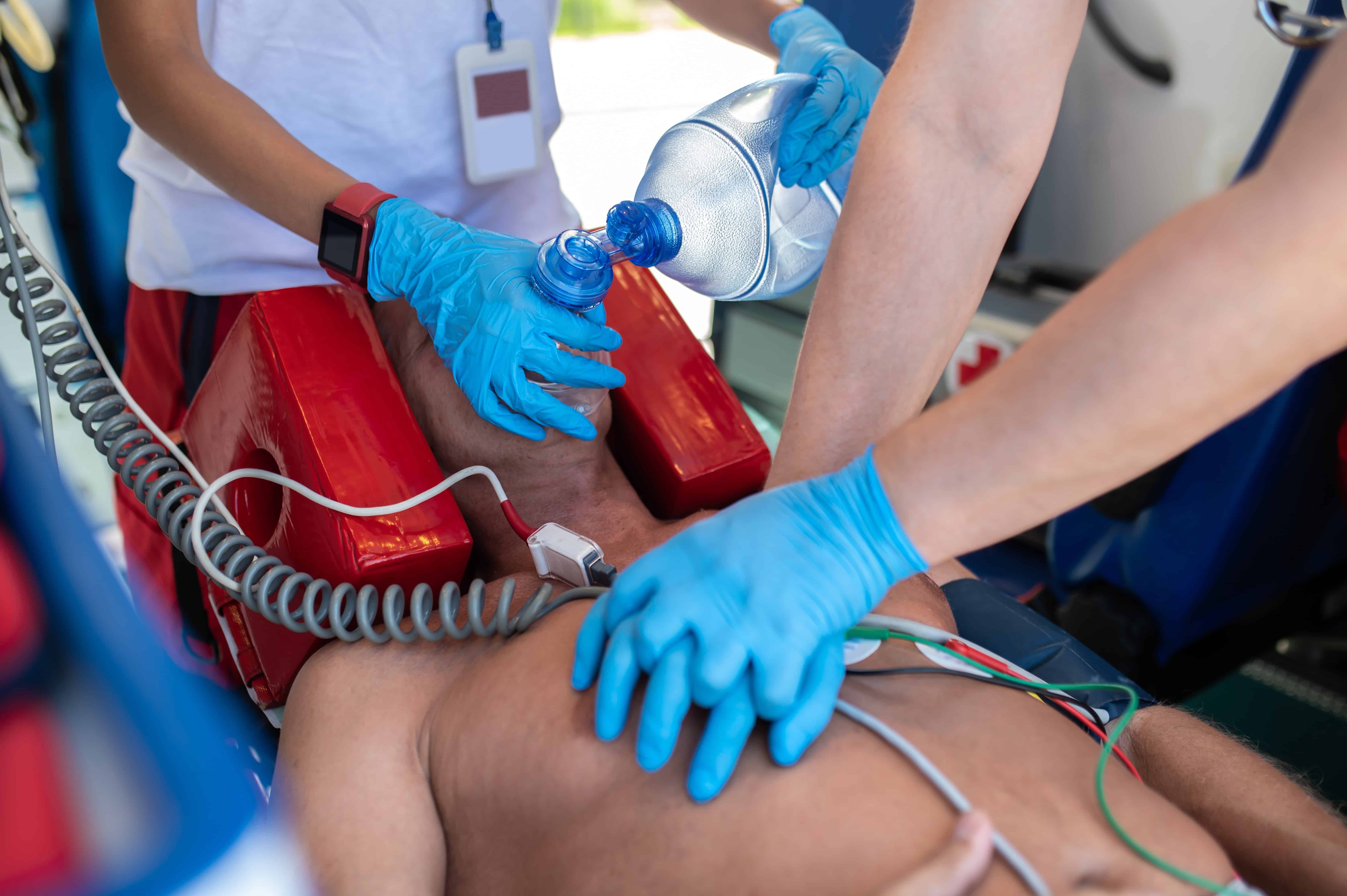 Close up of EMS team performing CPR on a man