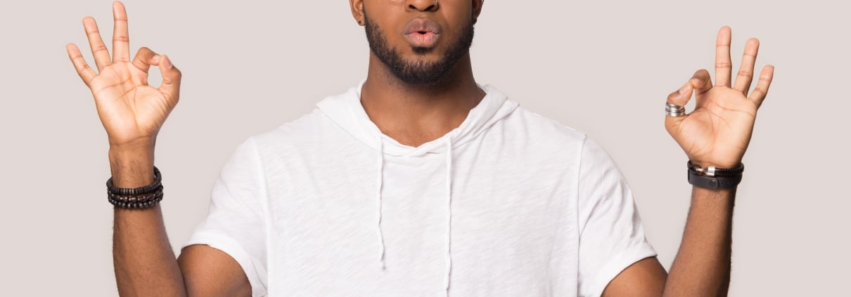Stressed African-American man in a meditation pose
