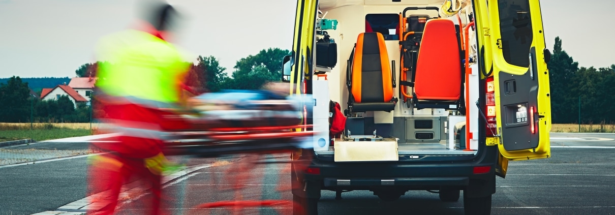 Blurred image of EMS professionals transporting a patient