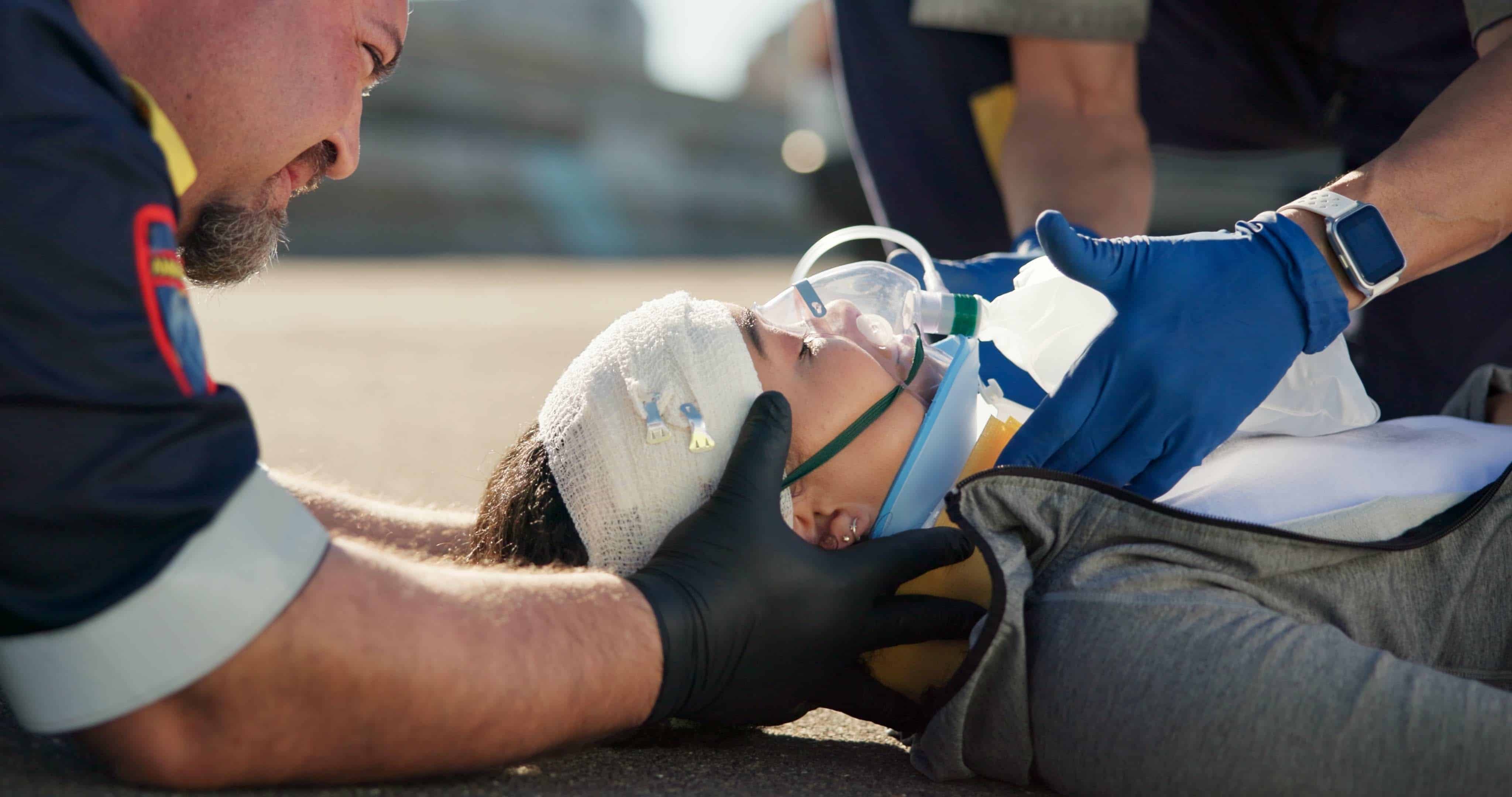Close up of an EMS team helping a car crash victim